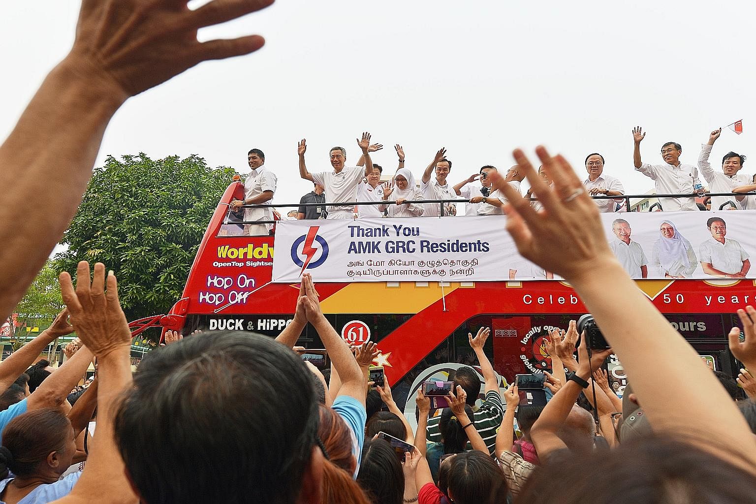 Prime Minister Lee Hsien Loong and his team making their way around Ang Mo Kio GRC on an open-top bus to thank voters last Saturday, the day after Polling Day.