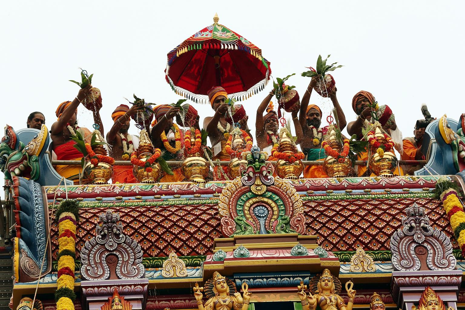 South Indian priests scaled the gopuram or tower of the Sri Ruthra Kaliamman Temple in Depot Road yesterday to sprinkle holy water from nine sacred Indian rivers, such as the Ganges, on its rooftop kalasams - vessel-like pinnacles that point to the s