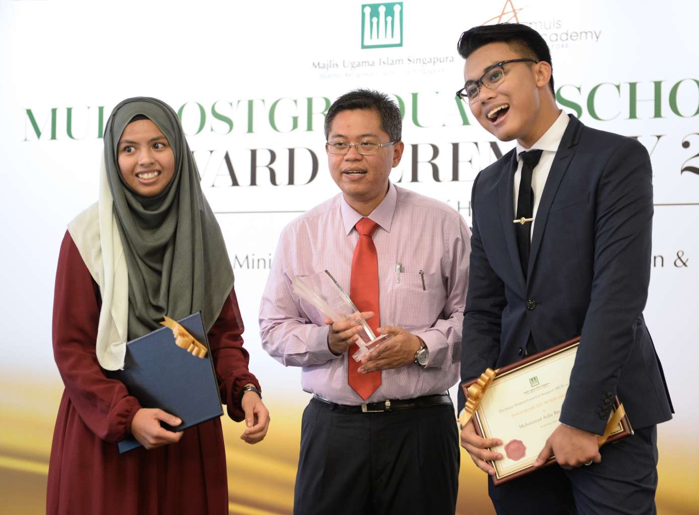 Dr Norshahril Saat (centre) won the first Syed Isa Semait Scholar Award yesterday while Ms Muneerah Abdul Razak received a Muis financial grant, and Mr Muhammad Azfar Anwar was given the Muis Postgraduate Scholarship Award.
