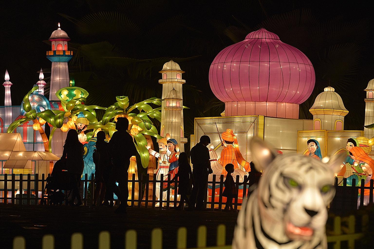 Visitors to the Supertree Grove last night enjoying a preview of the lanterns that will be on display at the annual Mid-Autumn Festival at Gardens by the Bay. Around 300 lamps, handmade by mastercraftsmen from Sichuan, China, were undergoing a light