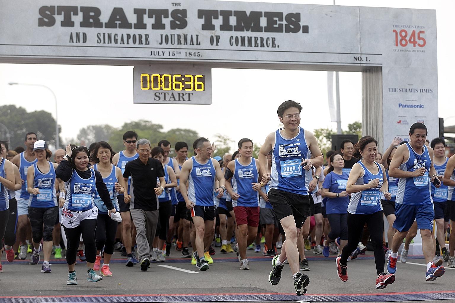 Minister for Culture, Community and Youth Lawrence Wong (foreground, third from right), the guest of honour at the event, participating in the 5km fun run with Singapore Press Holdings (SPH) chairman Lee Boon Yang (in black), Straits Times managing e
