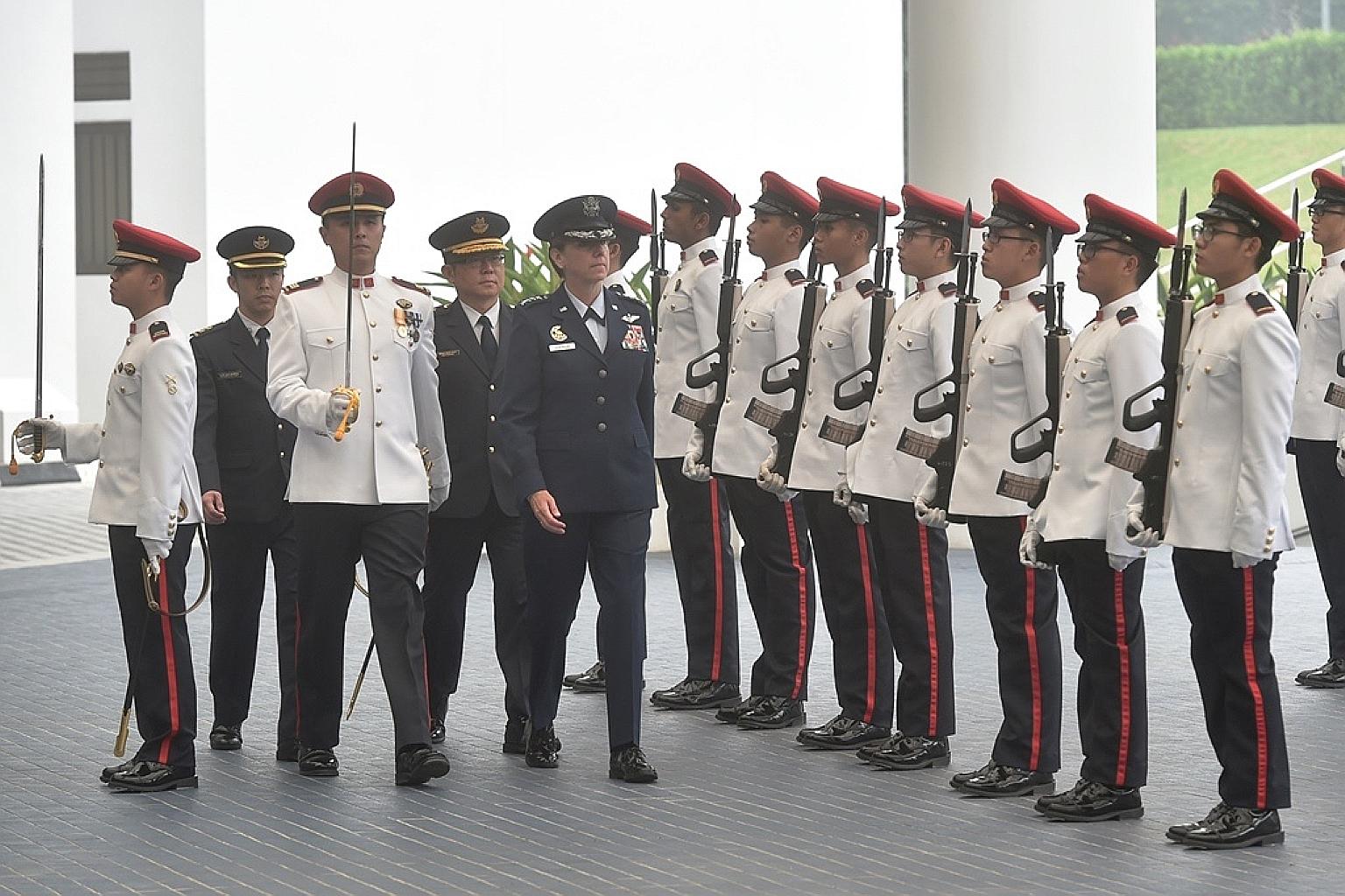 General Lori Robinson, Commander of the United States Pacific Air Forces, inspecting the Guard of Honour with Singapore's Chief of Air Force, Major-General Hoo Cher Mou (fourth from left), at the Ministry of Defence yesterday.