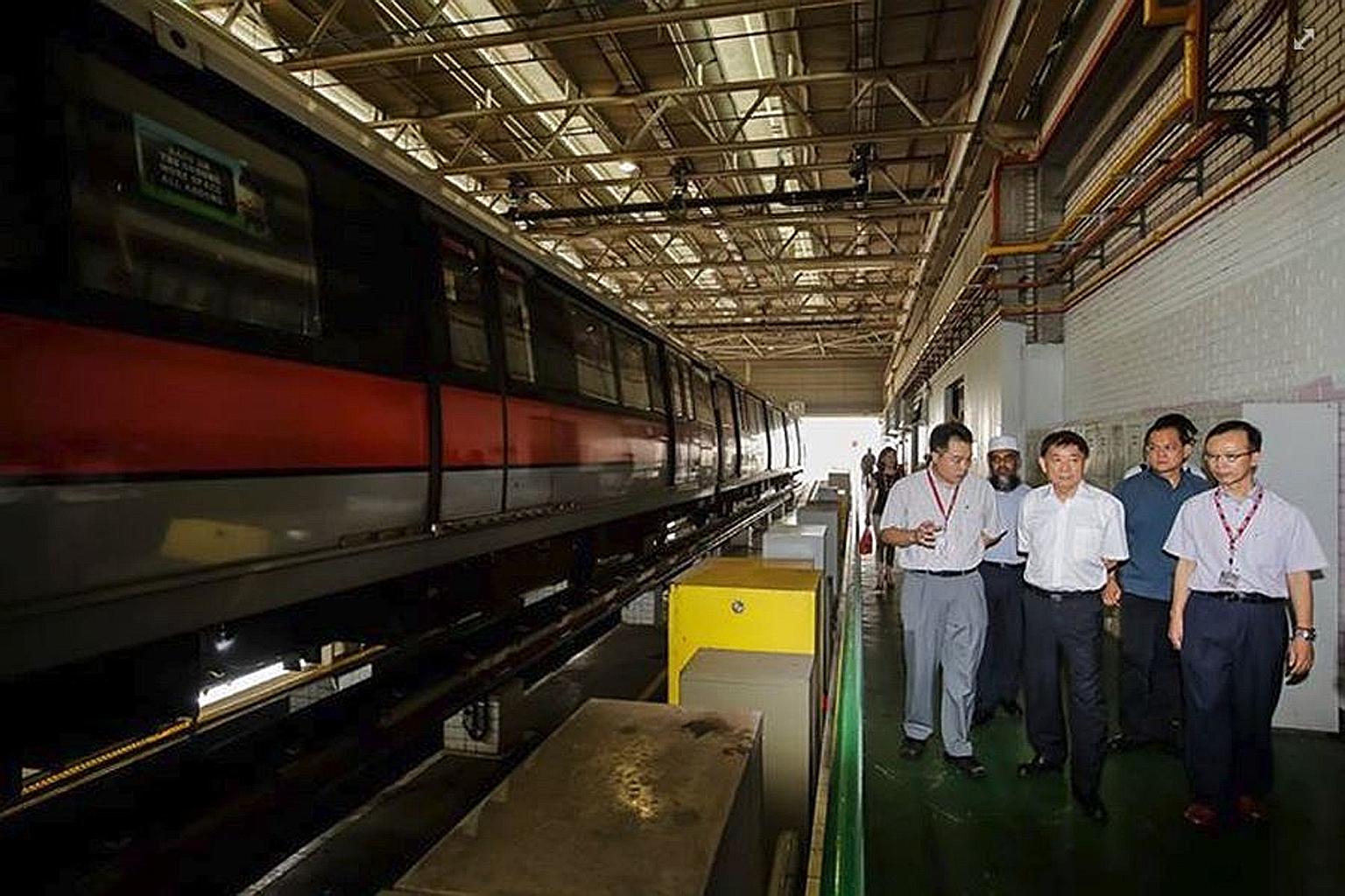 Mr Khaw Boon Wan (centre) during his visit to the SMRT's Bishan depot yesterday. He said he will be visiting depots and workshops to get to know the staff and gather feedback.