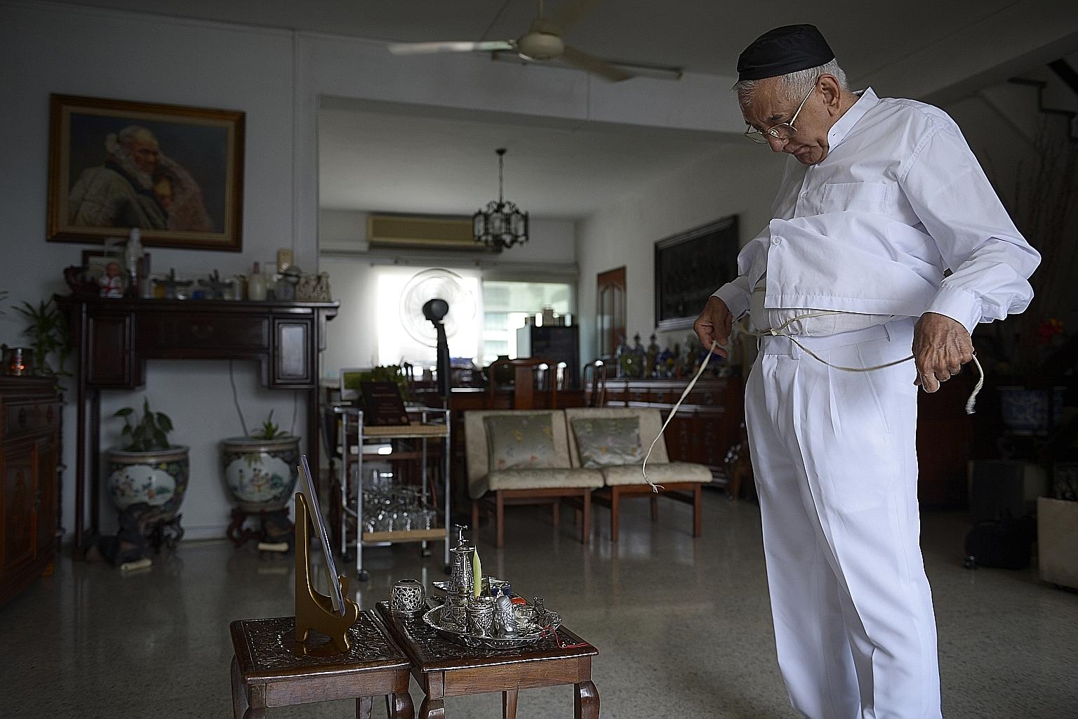 Mr Rustom Ghadiali, president of the Parsi Zoroastrian Association and one of the five priests here, praying at home.