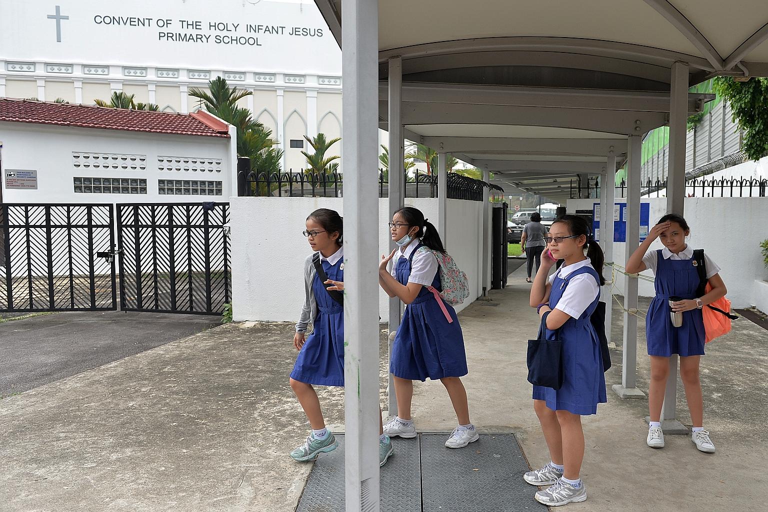 Primary 6 pupils from CHIJ Primary (Toa Payoh) leaving the school compound after their PSLE exam yesterday. Some 40,000 pupils took their first PSLE paper yesterday morning, many of them in air-conditioned halls and classrooms with air purifiers as t