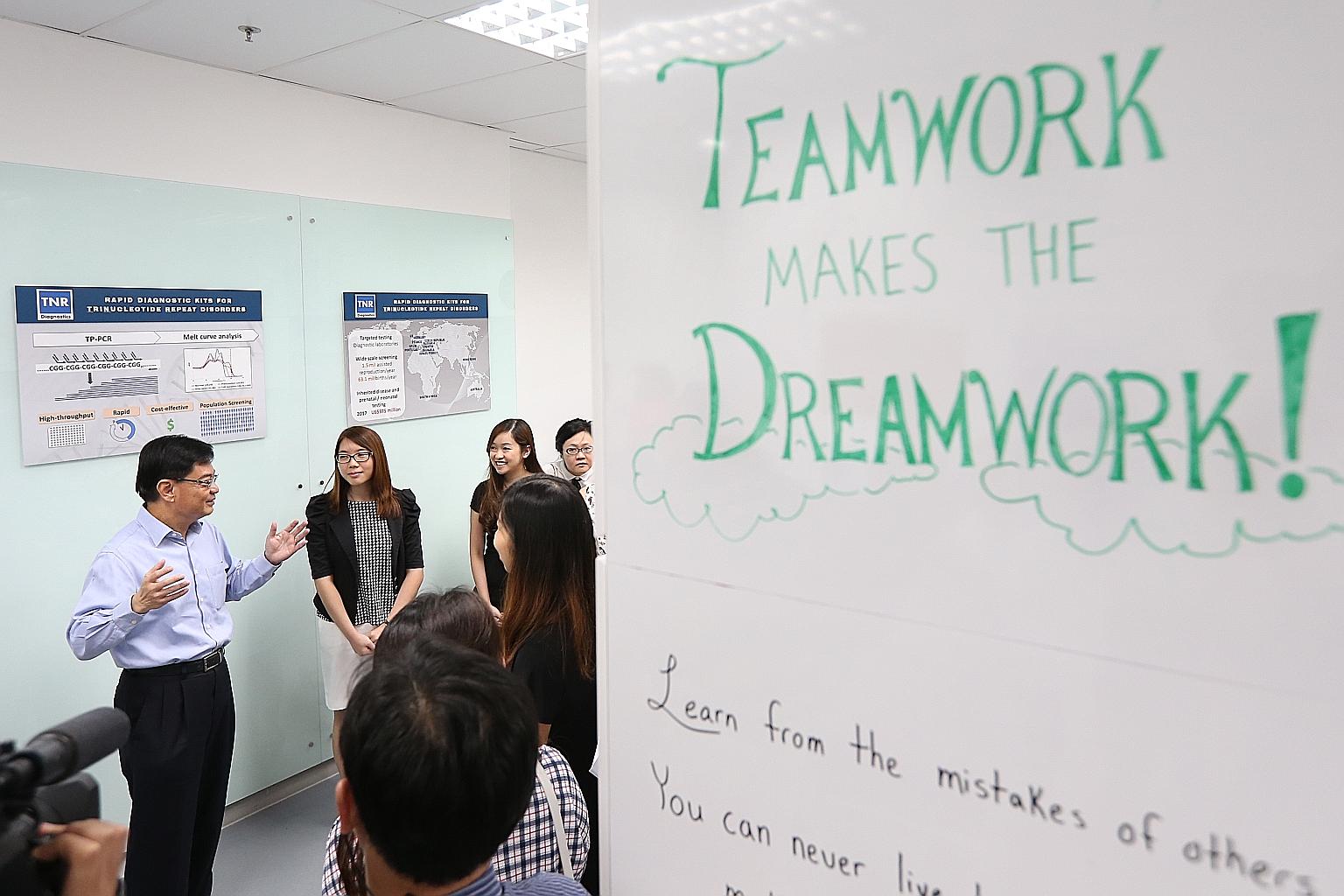 Finance Minister Heng Swee Keat touring the Biofactory, a biomedical incubator, during a visit to JTC LaunchPad @ one-north yesterday. To understand the effect of global and domestic changes, he said, "an important place to start has to be at our com