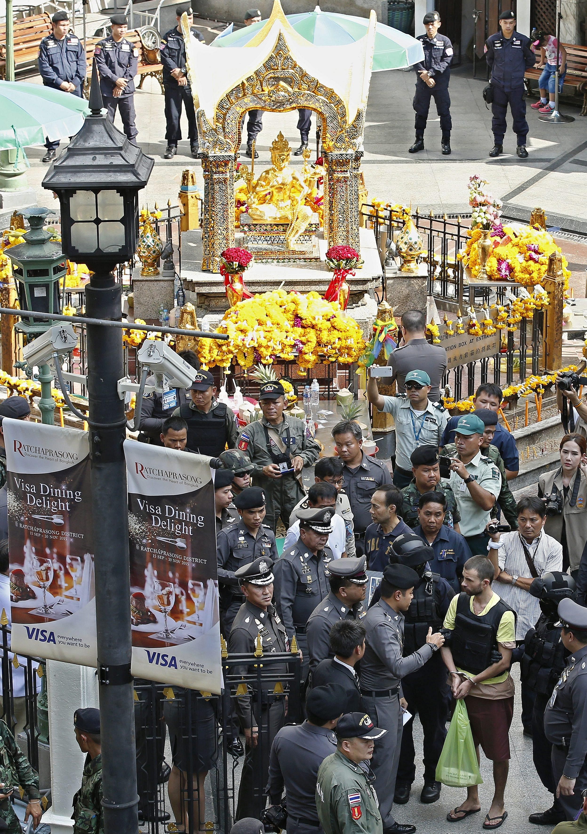 The Erawan bomb main suspect (in yellow vest) with police during a crime re-enactment last month at the blast site. If attacks do occur, countries need to have mechanisms to react quickly to ensure perpetrators are brought to justice.