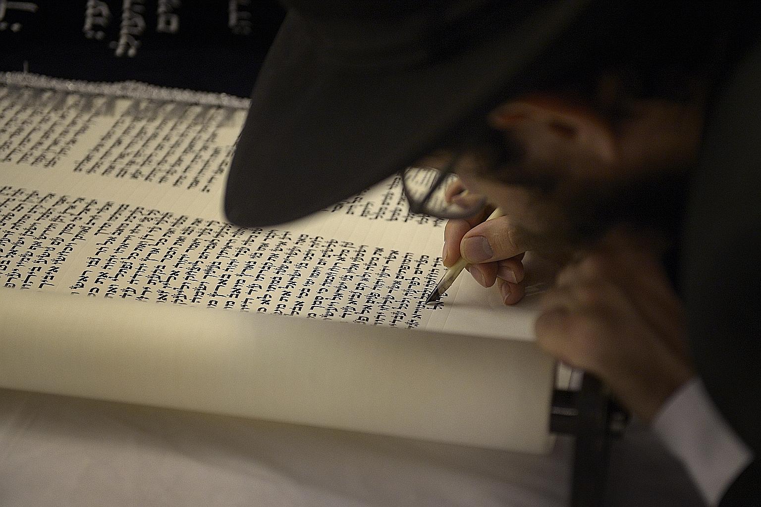 A new set of Torah - or Jewish written law - being completed at the Maghain Aboth Synagogue in Waterloo Street on Sept 30.