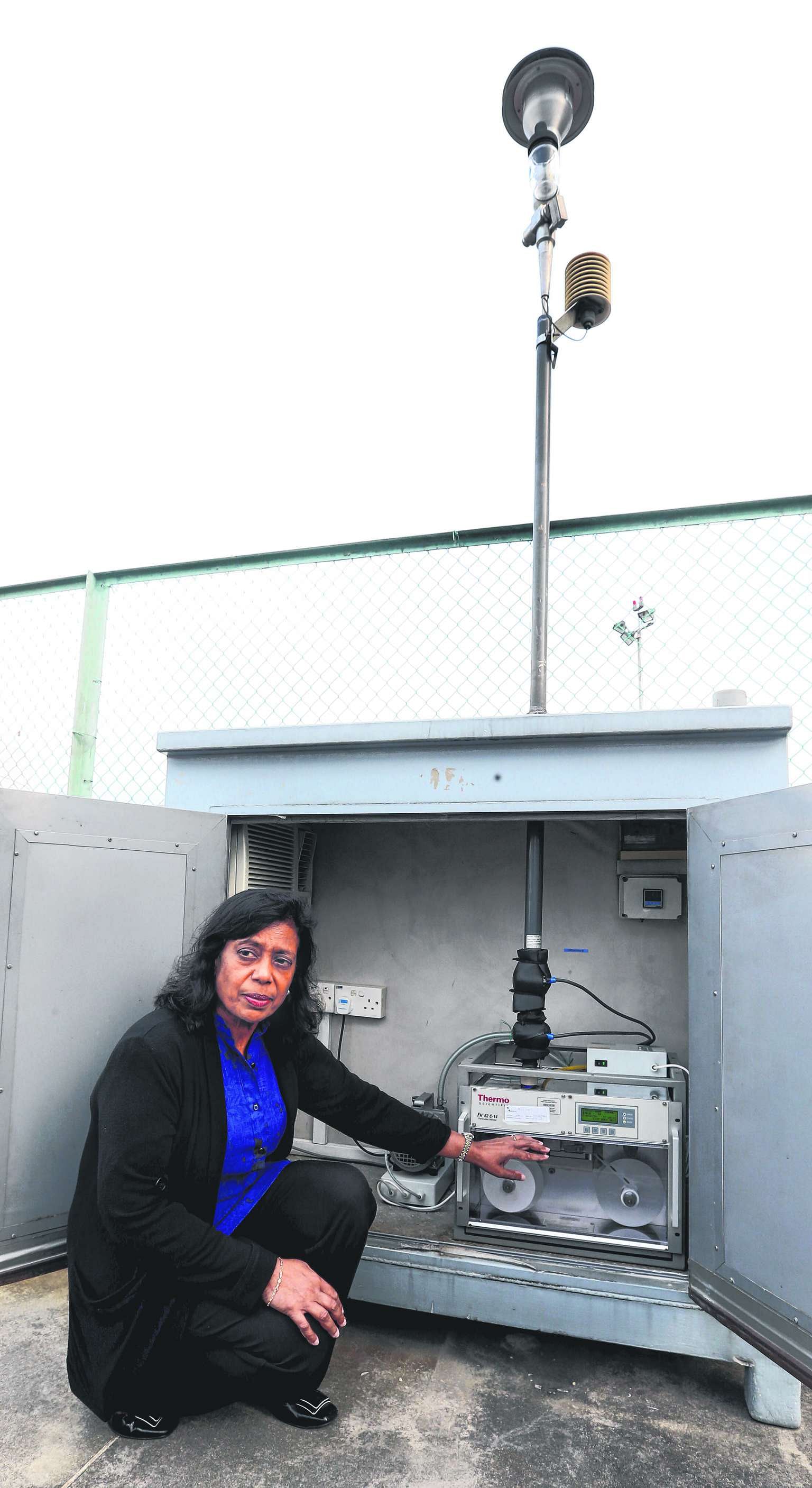 Mrs Indrani Rajaram with a machine used by NEA to help measure the concentration of PM2.5 in the air. Converting raw pollutant concentration data into one-hour PSI readings is not supported by health studies, she said.