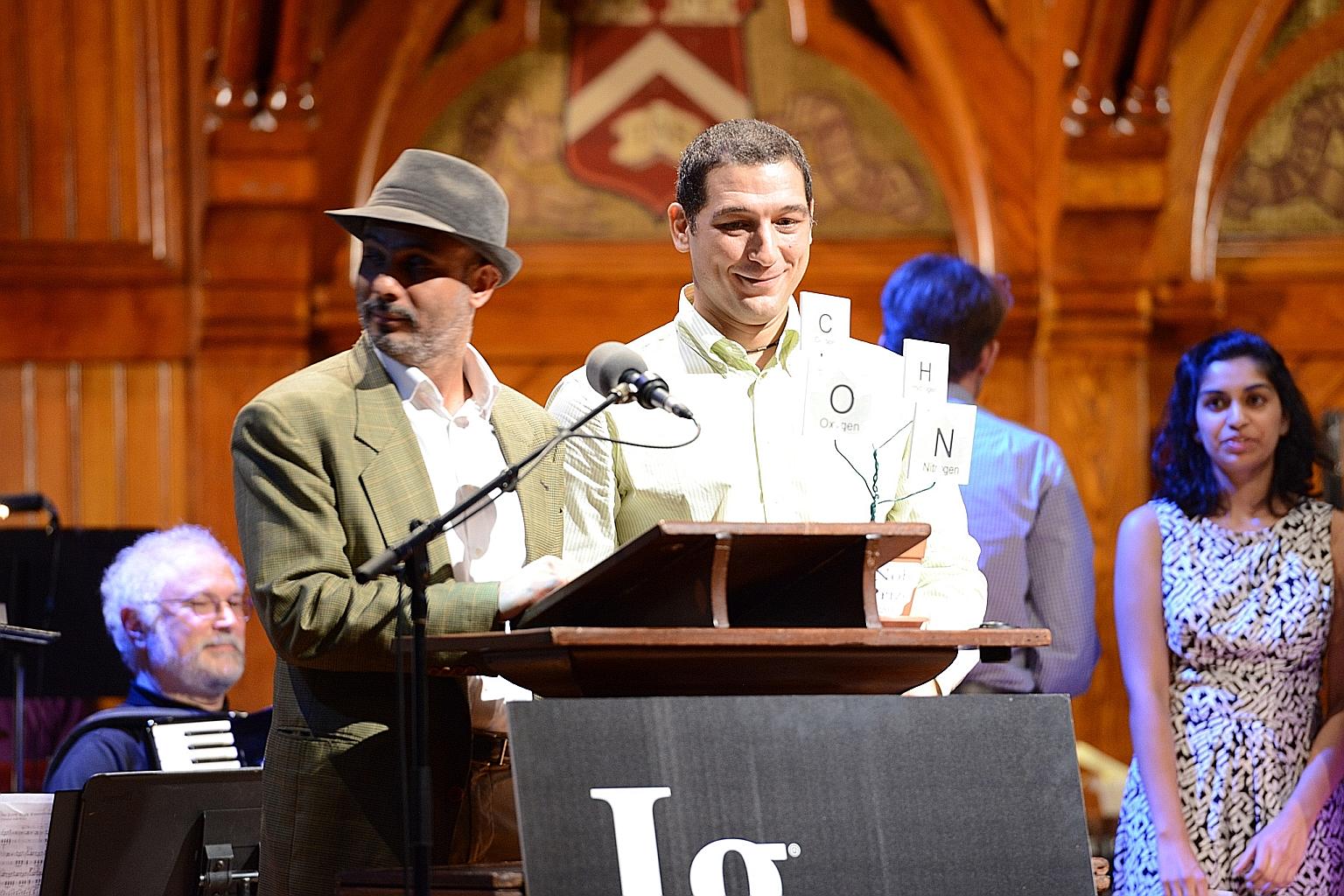 SMU's Assistant Professor of Finance Gennaro Bernile (right) receiving the Ig Nobel Prize with his co-researcher, Professor Raghavendra Rau, during the 2015 Prize Ceremony at Harvard University last month.