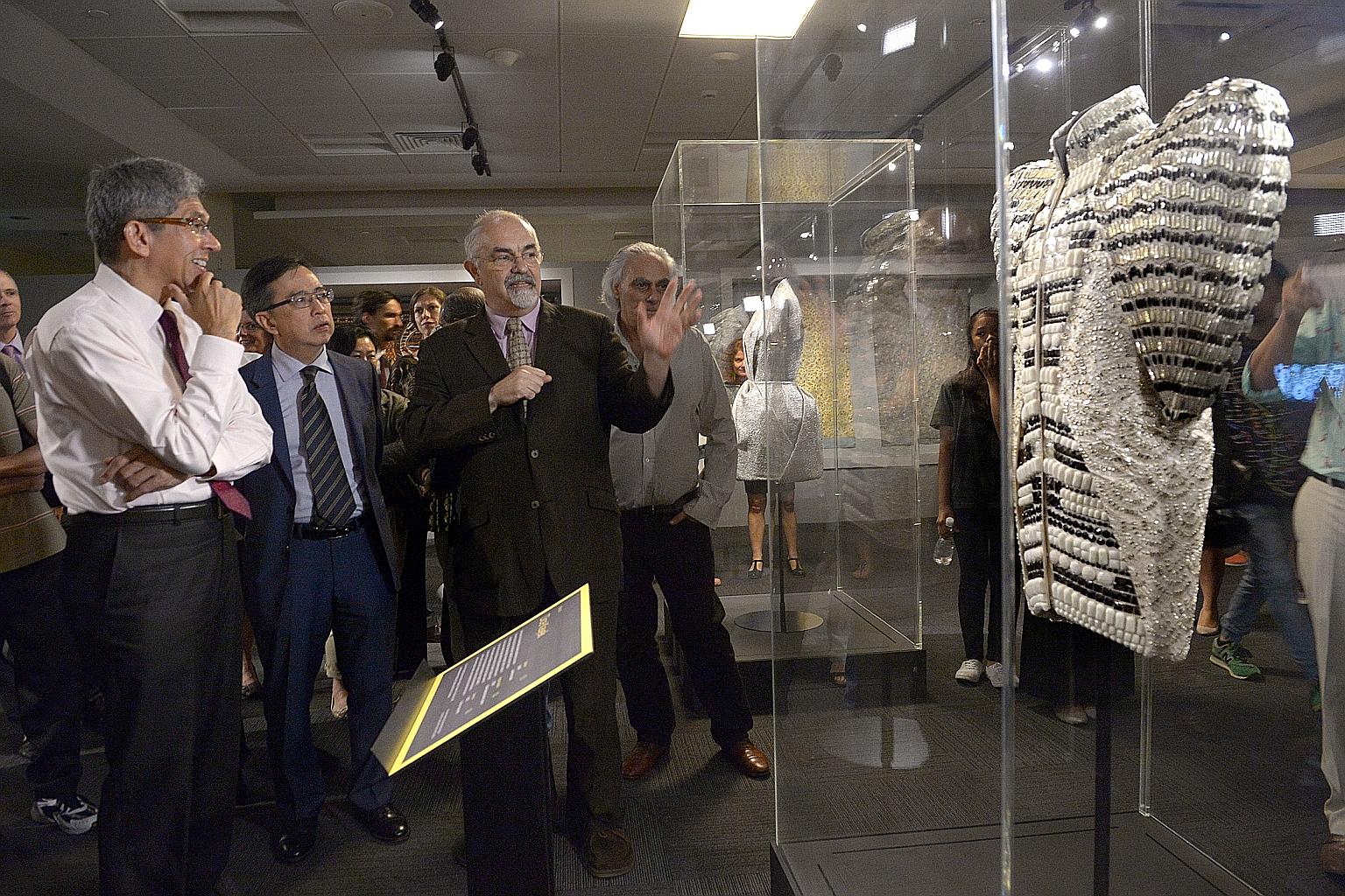 Viewing a dress made by Turkish fashion label Dice Kayek at the Jameel Prize 3 exhibition yesterday are (from left) Minister for Communications and Information Yaacob Ibrahim; NTU College of Humanities, Arts, and Social Sciences dean Alan Chan; and M