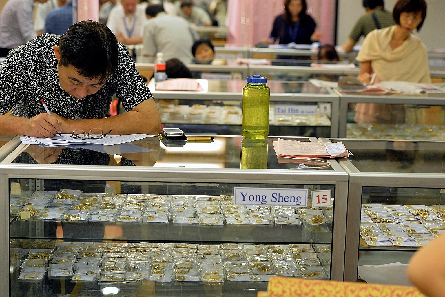 Potential bidders checking out auction items. The last two public auctions of unredeemed pawned valuables will be held on Saturday and on Oct 24.