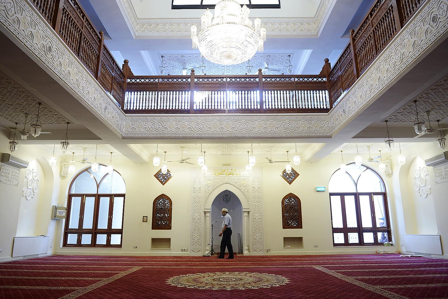 (Above): Gilded inscriptions of the different names of Allah adorn the Masjid al Burhani in Hill Street. The prayer hall consists of two floors - the upper storey for the women and the ground floor for the men. (Right): Men from the Dawoodi Bohra com