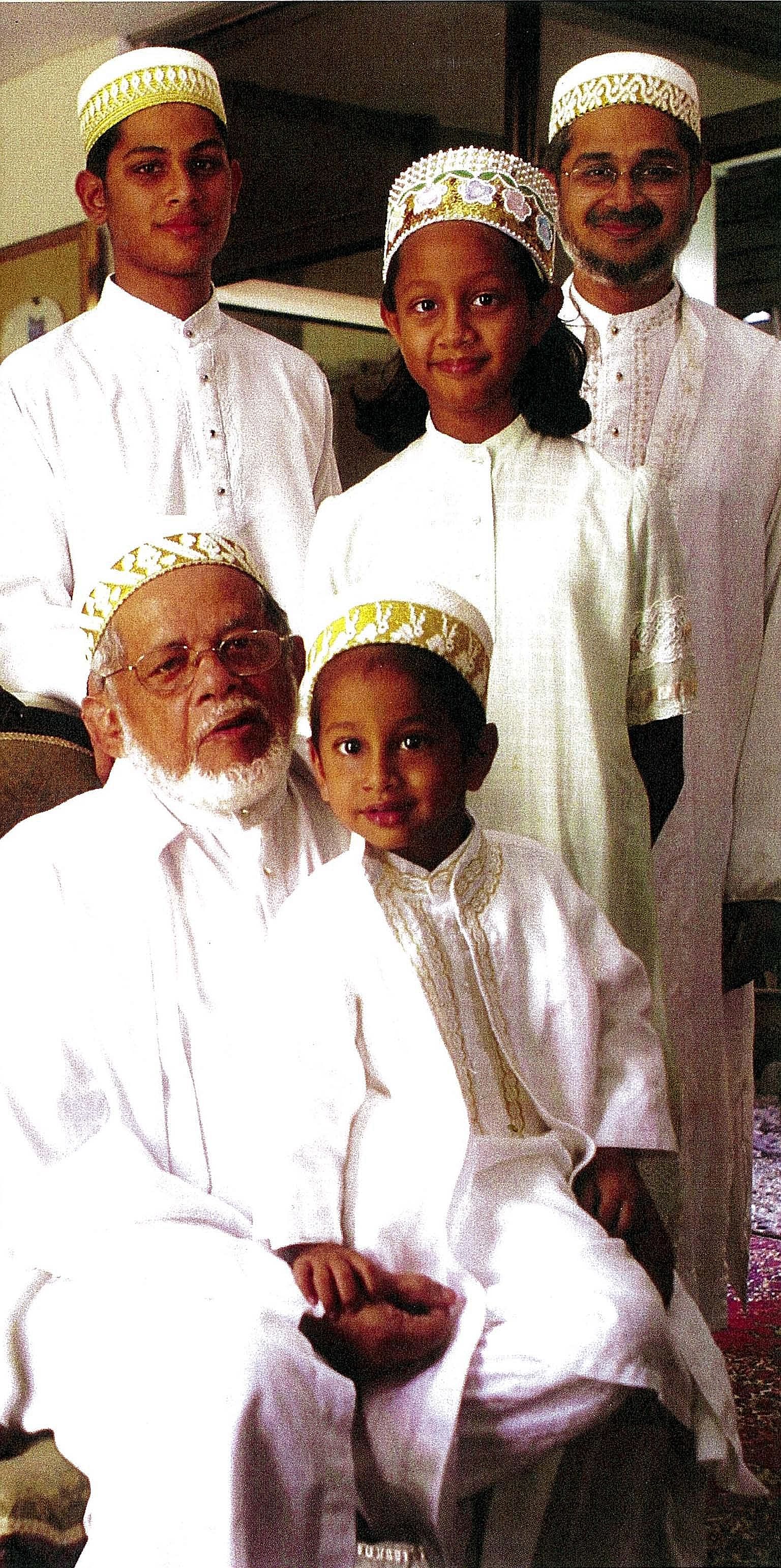 (Above): Spice trader Moez Nomanbhoy (right) and his son Hanif. (Left): An old photograph of Mr Moez Nomanbhoy (with his youngest grandson Aliasger on his lap). Standing: Mr Hanif (right) with his daughter Sakina and son Aqeel.