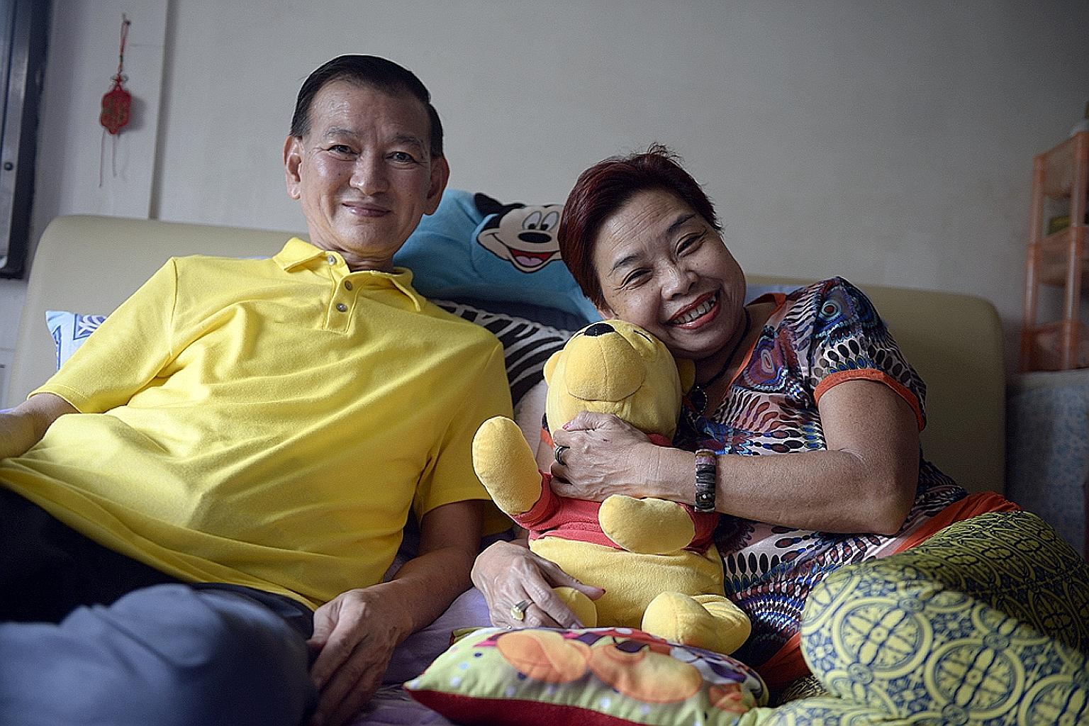 Madam Mary Chan hugging a Winnie the Pooh soft toy that belonged to her foster child, who passed away at age 13 in April as a result of complications from a stomach surgery. Seen with her is husband Jack Tan, 68.