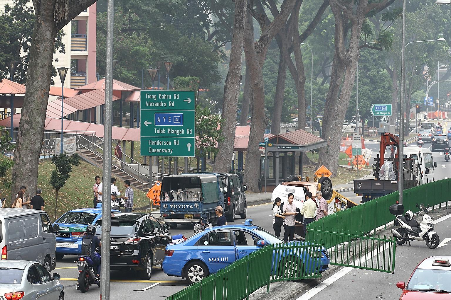 The accident scene in Jalan Bukit Merah. The Comfort taxi had backed into another cab before accelerating forward and clipping the rear left wheel of yet another cab travelling on the main road, causing it to flip over.