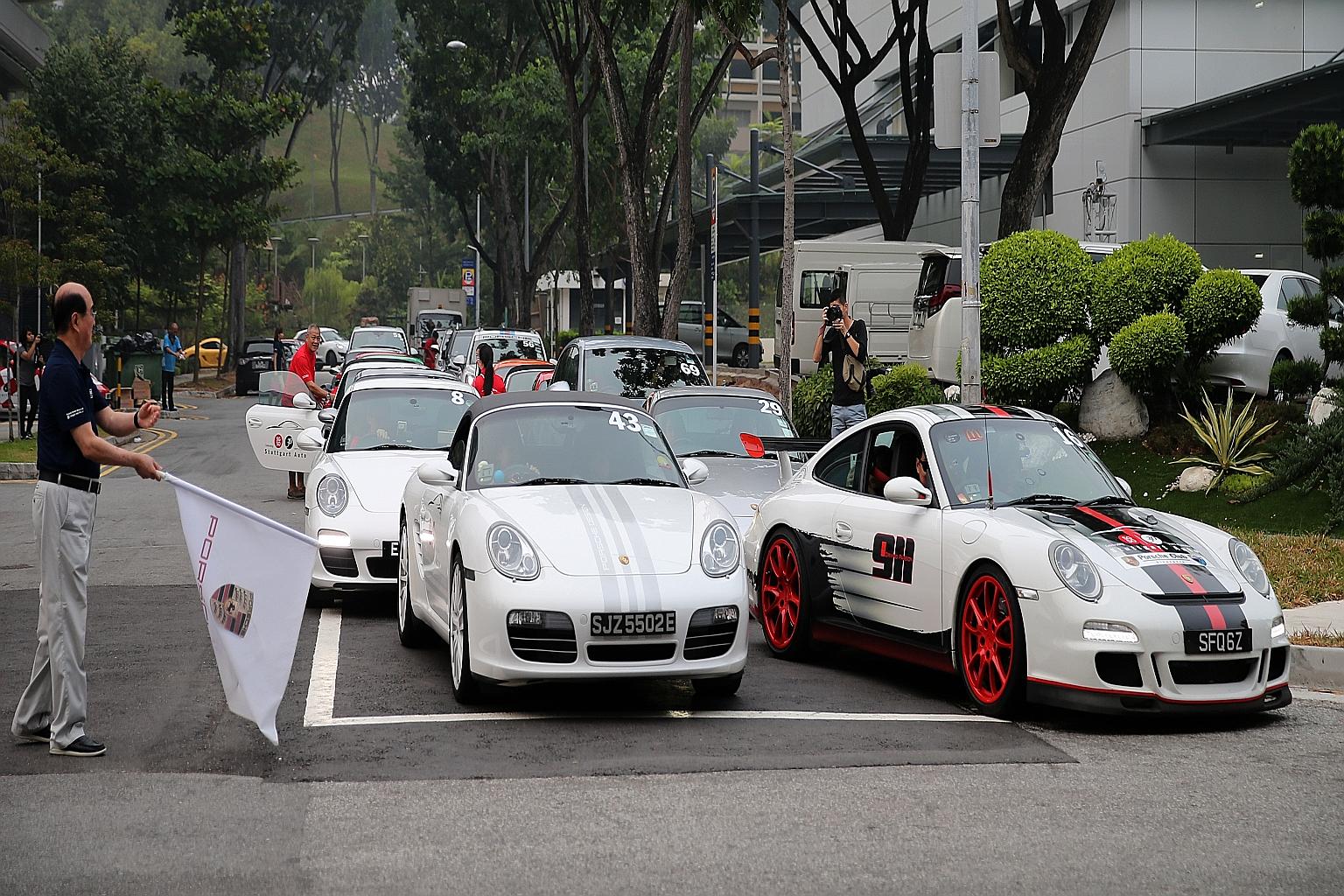 Eurokars Group executive chairman Karsono Kwee flagging off the Porsche convoy yesterday. Sixty-six Porsches took part in the fund-raising activity.