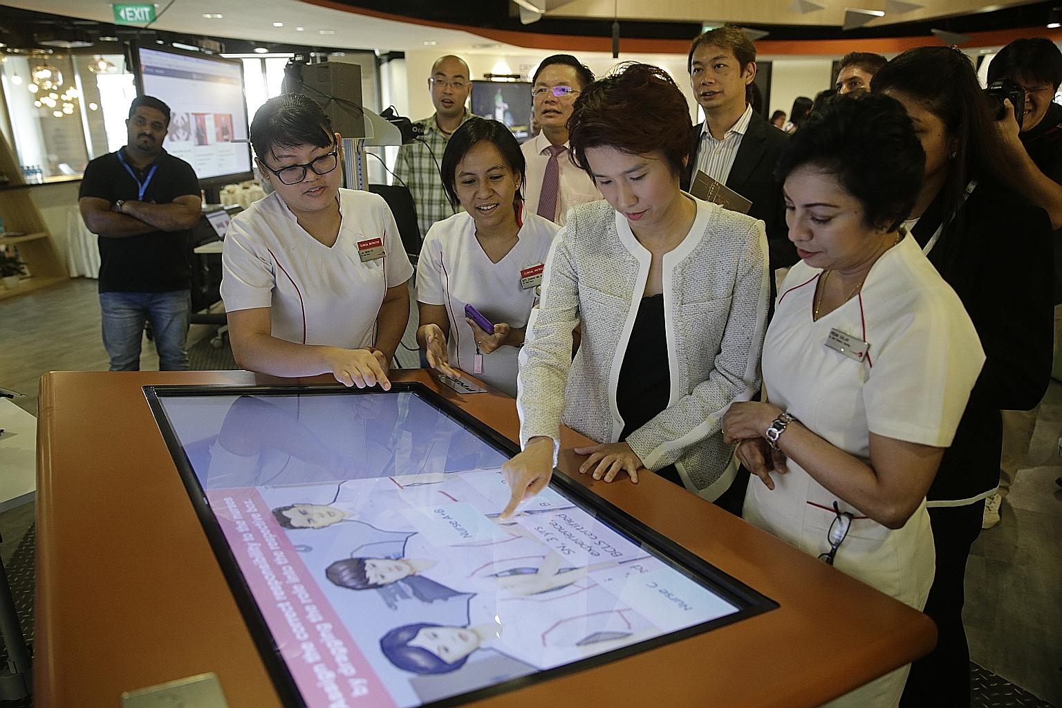 Education and Trade and Industry Parliamentary Secretary Low Yen Ling trying a game at an exhibition at the Lifelong Learning Institute during the launch of iN.Learn 2020 and the opening of learning facility iN.LAB.