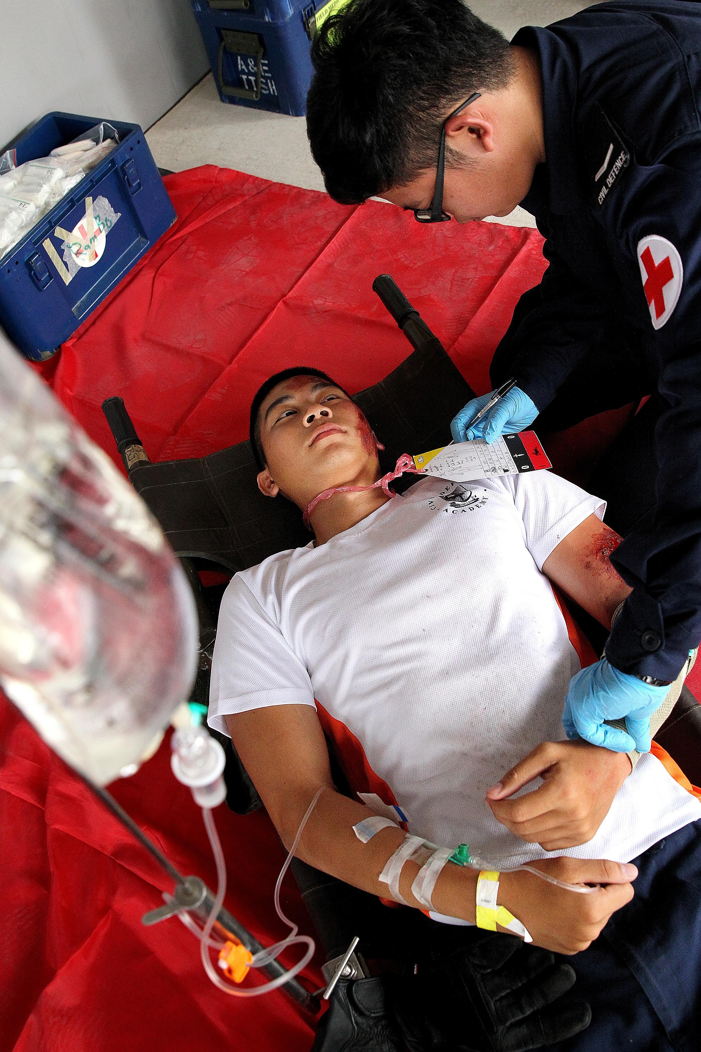 Singapore Civil Defence Force personnel attending to a "casualty" following a simulated terrorist attack at the Sports Hub during a media preview of Exercise Northstar on April 30.