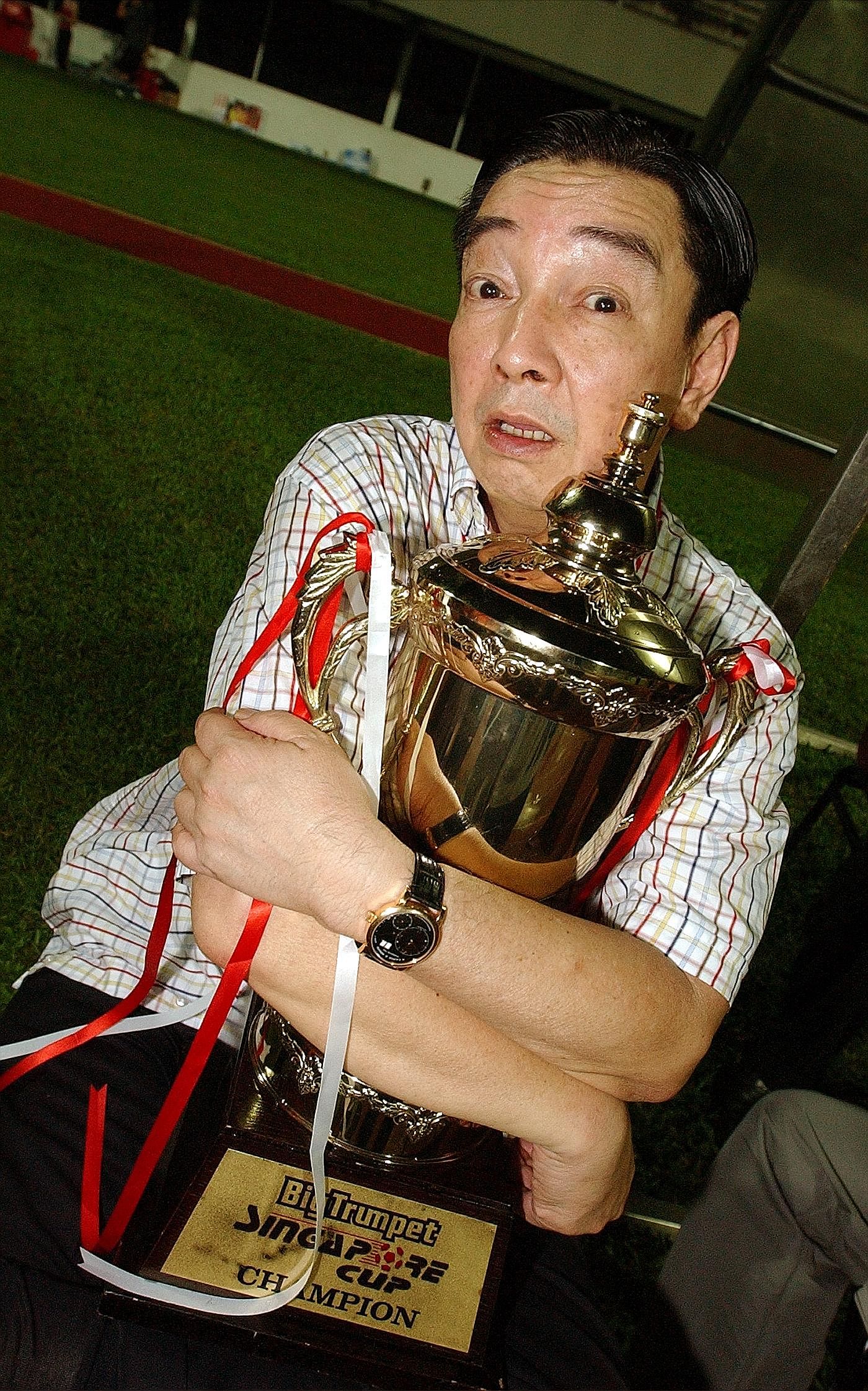 Teo Hock Seng back in 2004 with the Singapore Cup trophy. In 15 years as the Stags' chairman, he took pleasure in winning silverware and developing young players rather than aiming for lucrative returns.