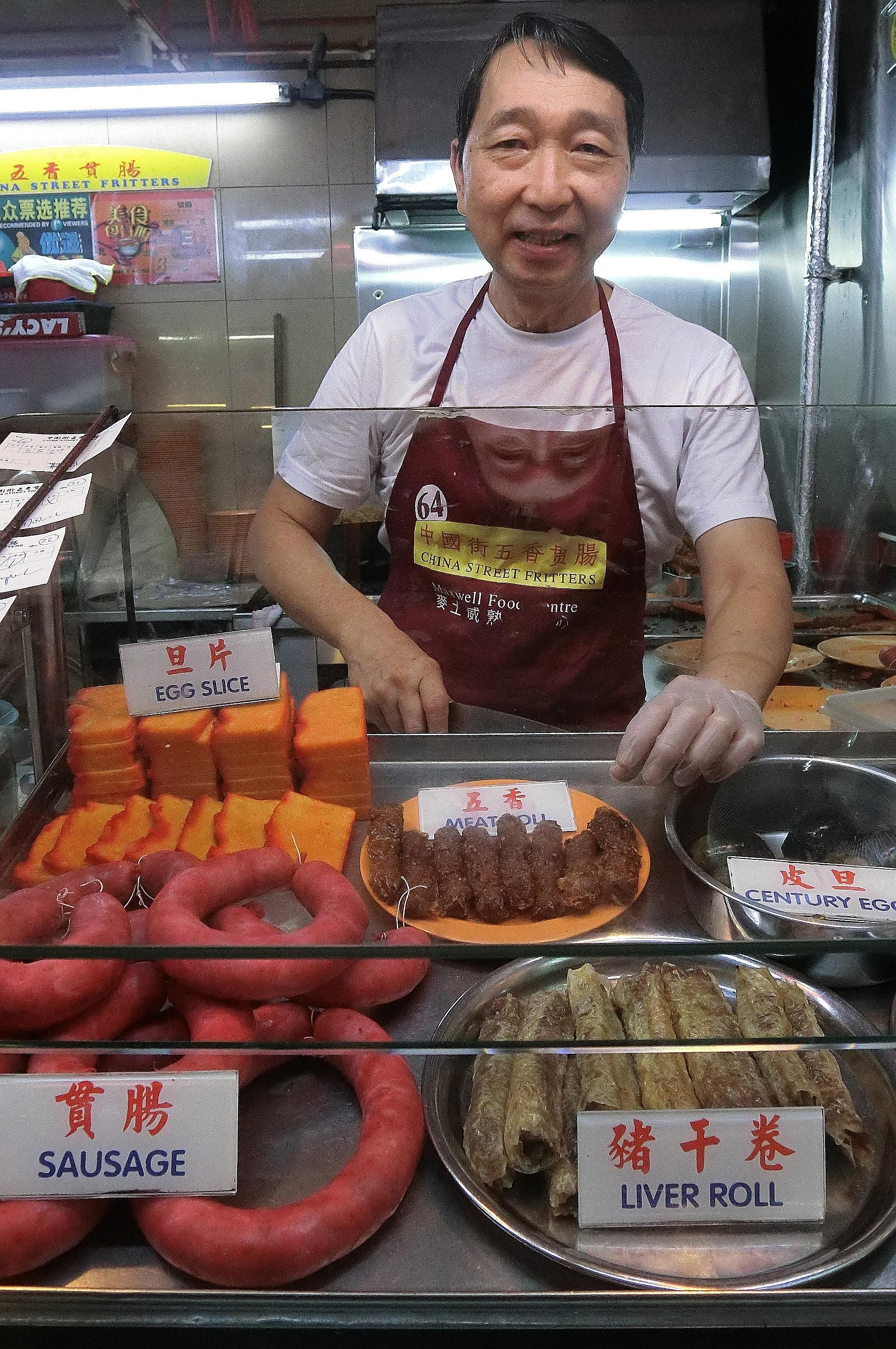 Mr Ng Kok Hua sells handmade Hokkien ngoh hiang at China Street Fritters, a stall in Maxwell Food Centre which won a Heritage Hawker Stall award.