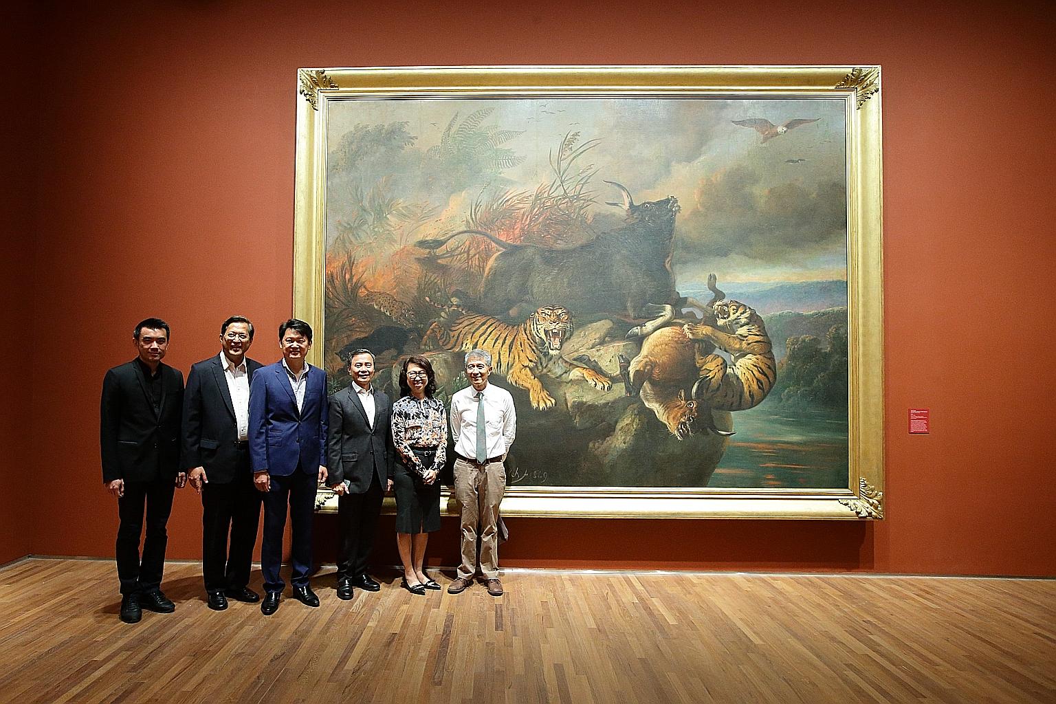 Mr Danny Yong (third from left), with (from left) National Gallery Singapore director Eugene Tan, board member Jose Isidro Camacho, chairman Hsieh Fu Hua, CEO Chong Siak Ching and board member Kenson Kwok, in front of Forest Fire, a painting dedicate