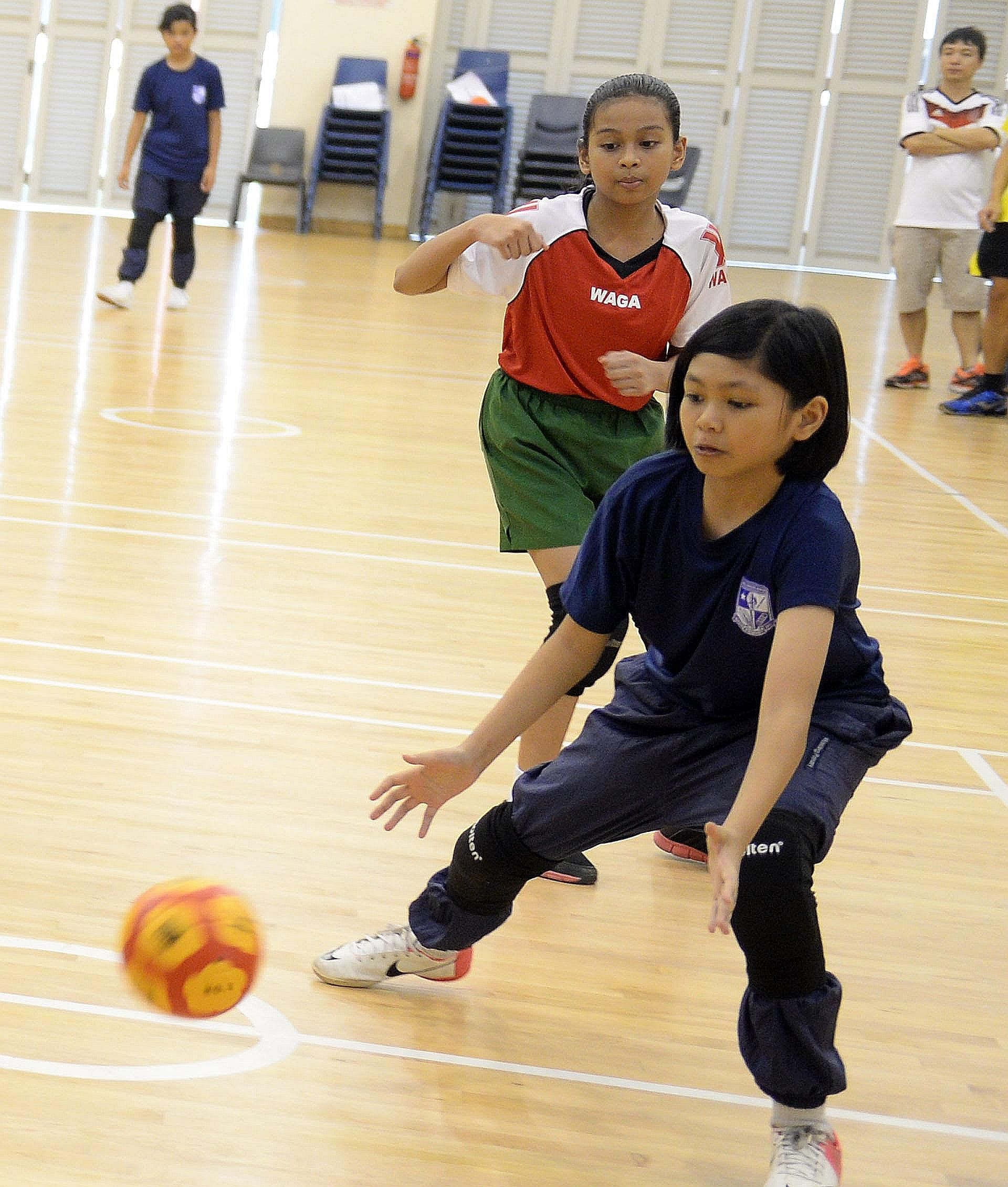 A Marsiling Primary School pupil (in blue) attempting to catch the ball against Greendale Primary at the SPH Foundation National Primary Schools Tchoukball tournament yesterday. Greendale won 6-1. Junyuan Primary won the girls' round-robin event and 