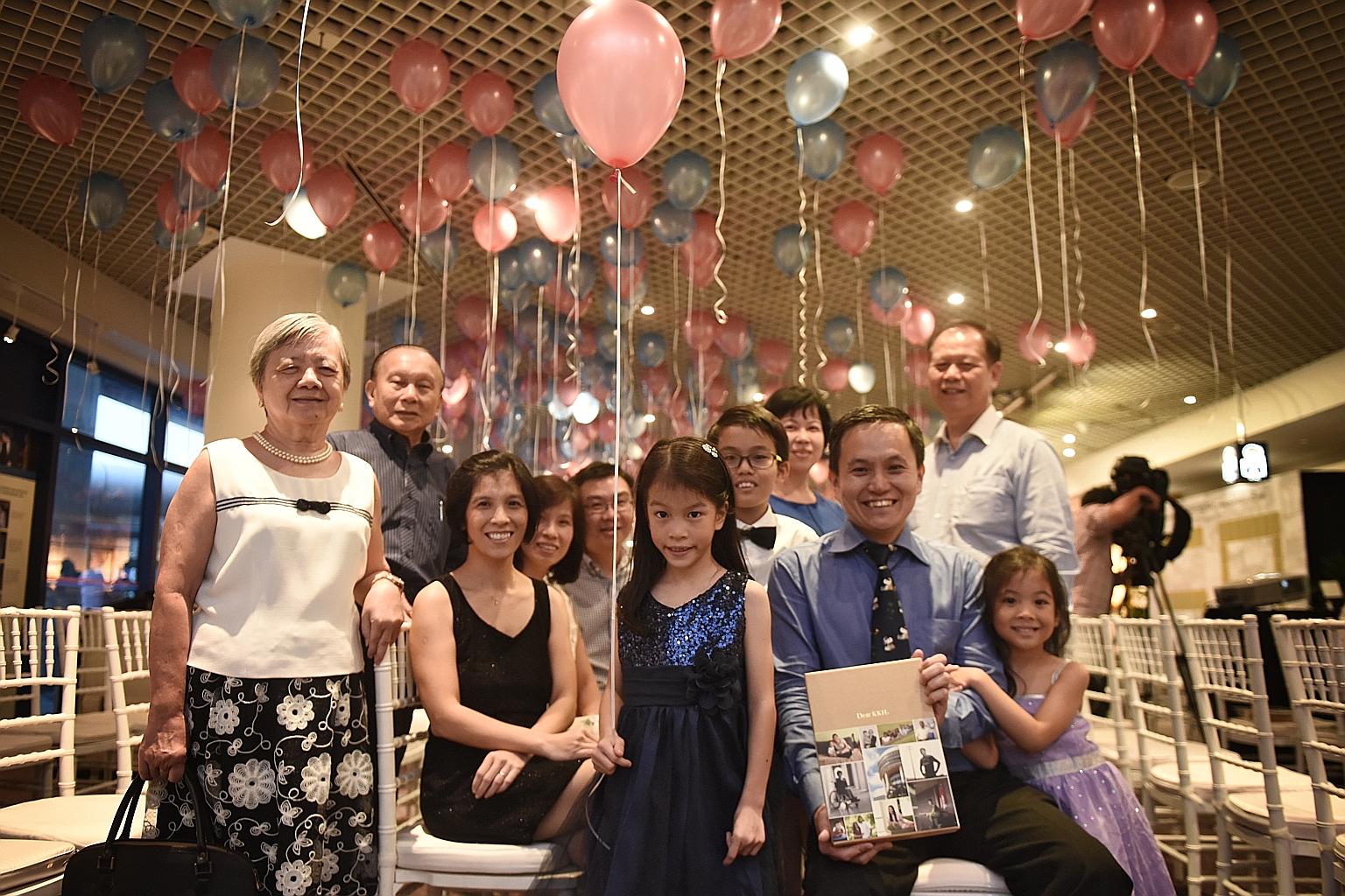 Kylie Tan (centre), seven, her siblings Brian (back, with bow tie), 11, and Sarah (far right), six, with their parents Tan Chin Hwee (right) and Michelle Lee (left, in black) and their extended family at yesterday's book launch.