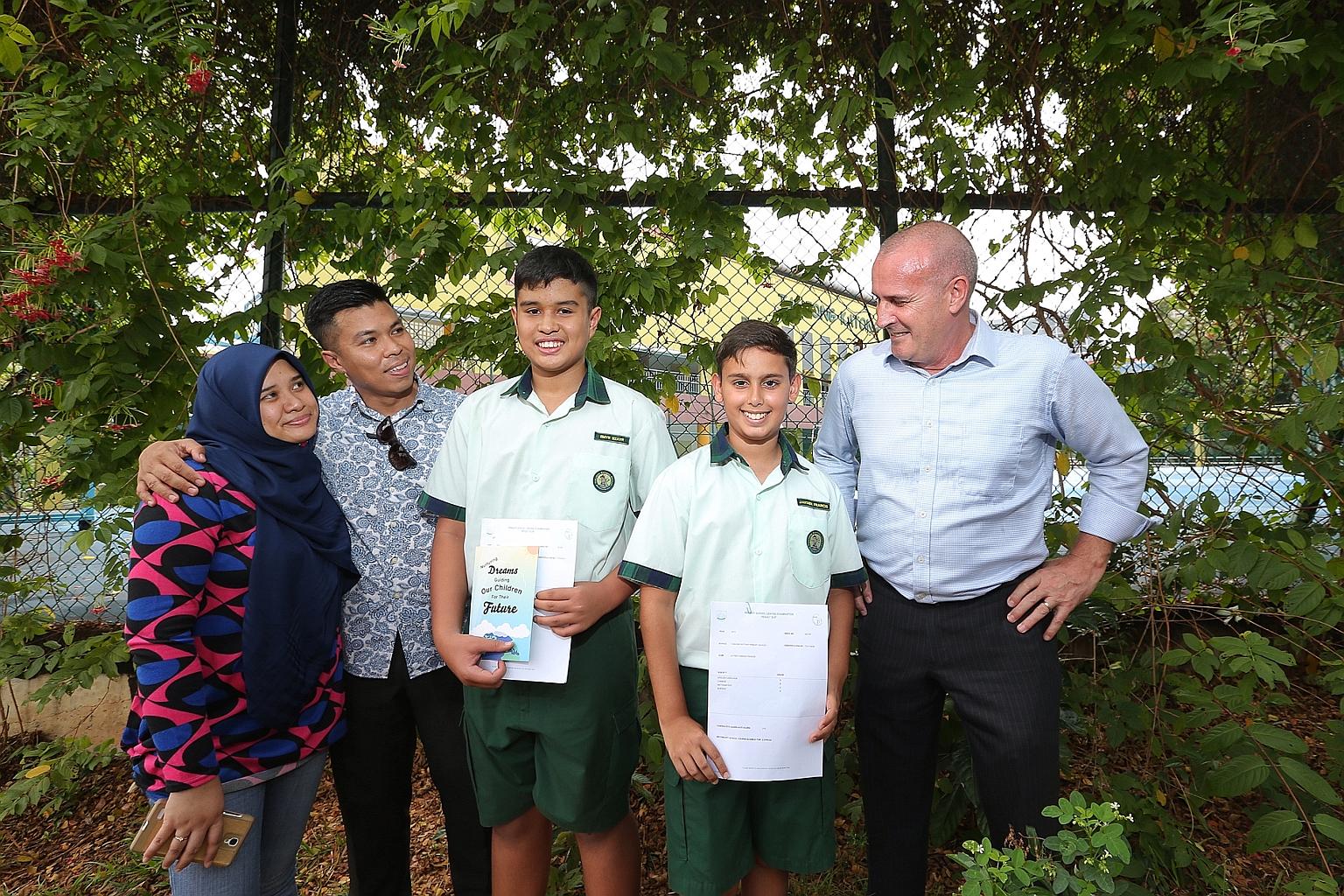 (From left) Madam Nur Aryana Aziz; her husband, Mr Sadri Farick; their son, Emyr Uzayr; Jayden Francis, and his father, Mr Dannie Francis, at Tanjong Katong Primary School yesterday.