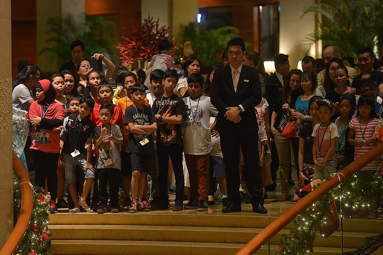 Beneficiaries and guests watched the Christmas light-up at The Fullerton Hotel's grand atrium yesterday.