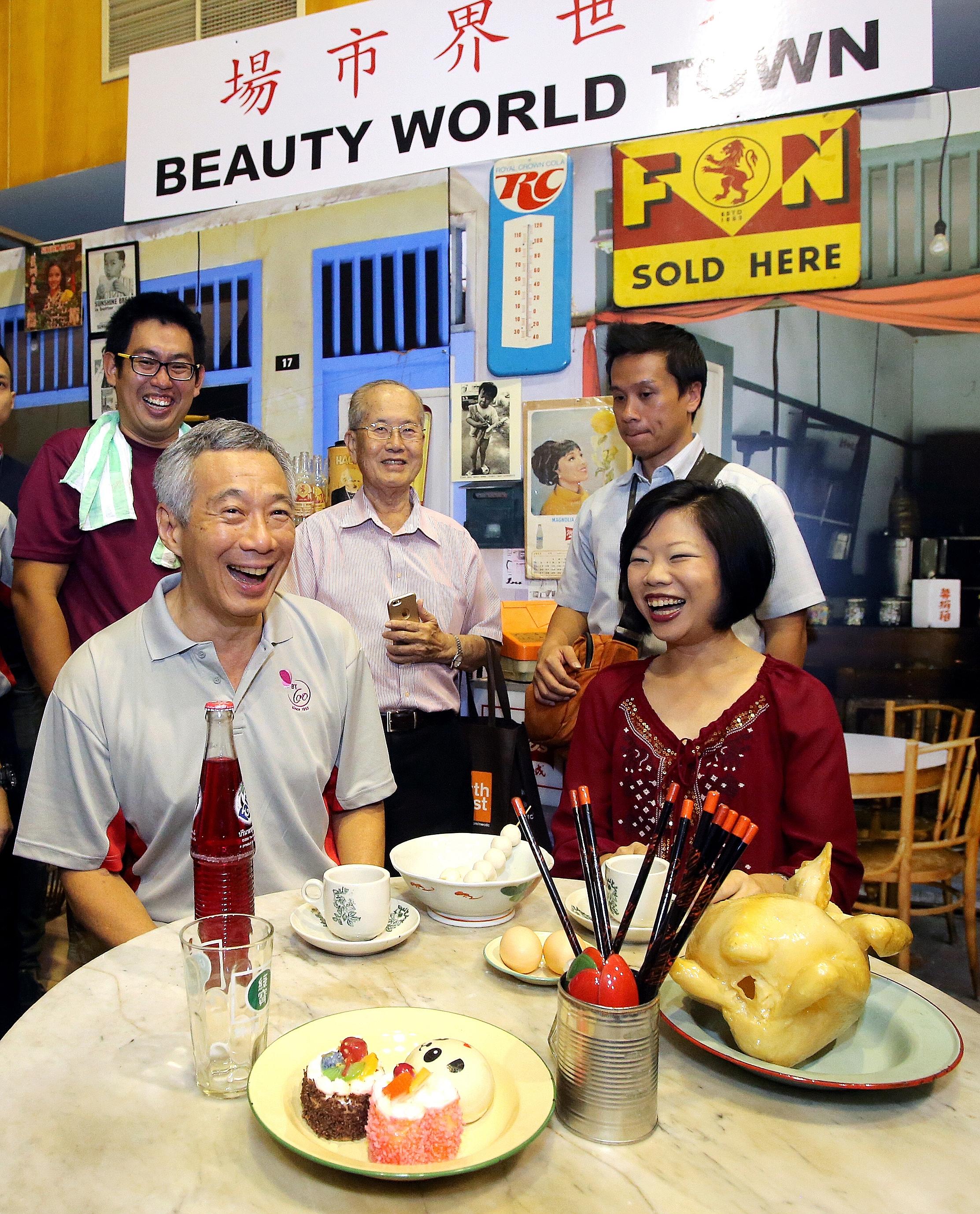 PM Lee and Ms Sim at the carnival yesterday to mark the constituency's 60th anniversary. Three books celebrating the area's heritage, and the Bukit Timah Eldercare Project were launched at the event.