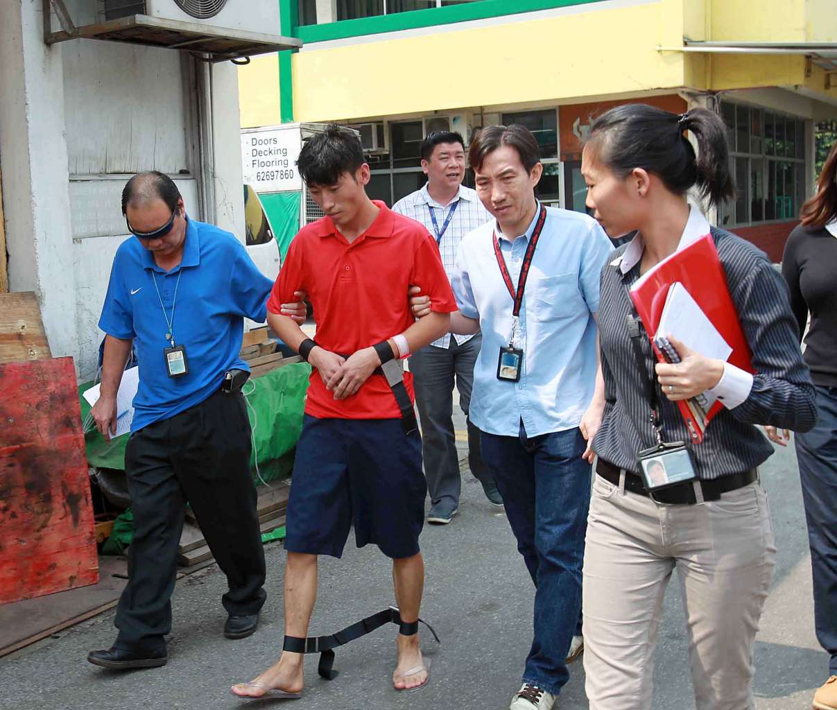 Chinese national Li Yongxiang revisiting the crime scene on June 24, 2013. Li had originally been charged with murder, but a government psychiatrist found that he had a major depressive episode at the time, reducing his mental responsibility for his acts.
