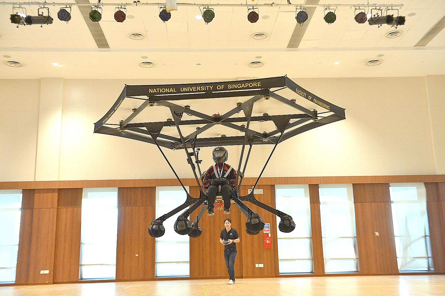 Snowstorm, carrying NUS chemical engineering student Zheng Xiaowen, taking off during a test flight at the university yesterday. The aircraft, which took a year to build, can carry an individual weighing up to 70kg for about five minutes, and can ris
