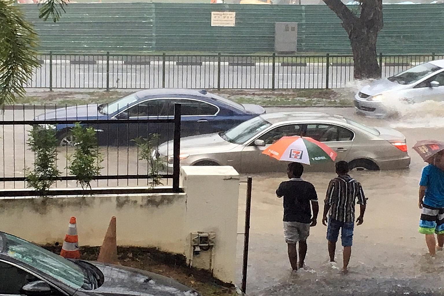 Cars stranded in floodwaters along Yio Chu Kang Road, just outside the Church of St Vincent de Paul. Yesterday's downpours pushed water levels in drains and canals close to the brink, with flooding reported in areas such as Ang Mo Kio, Buangkok, Houg