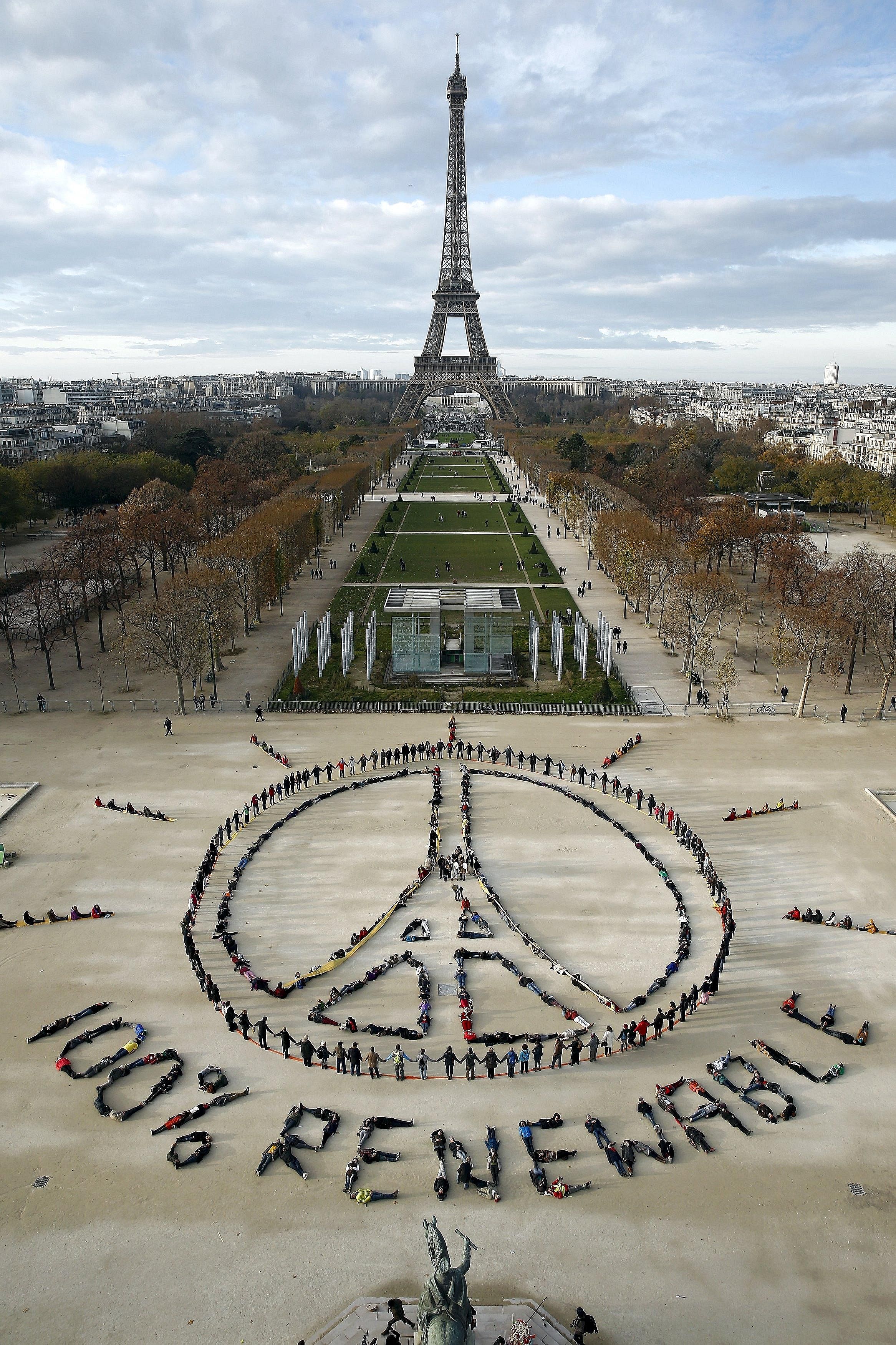 Environment activists forming a message of peace in front of the Eiffel Tower in Paris on Sunday as the World Climate Change Conference took place in the city. The writer says one of the great challenges in the push to save the planet is that climate