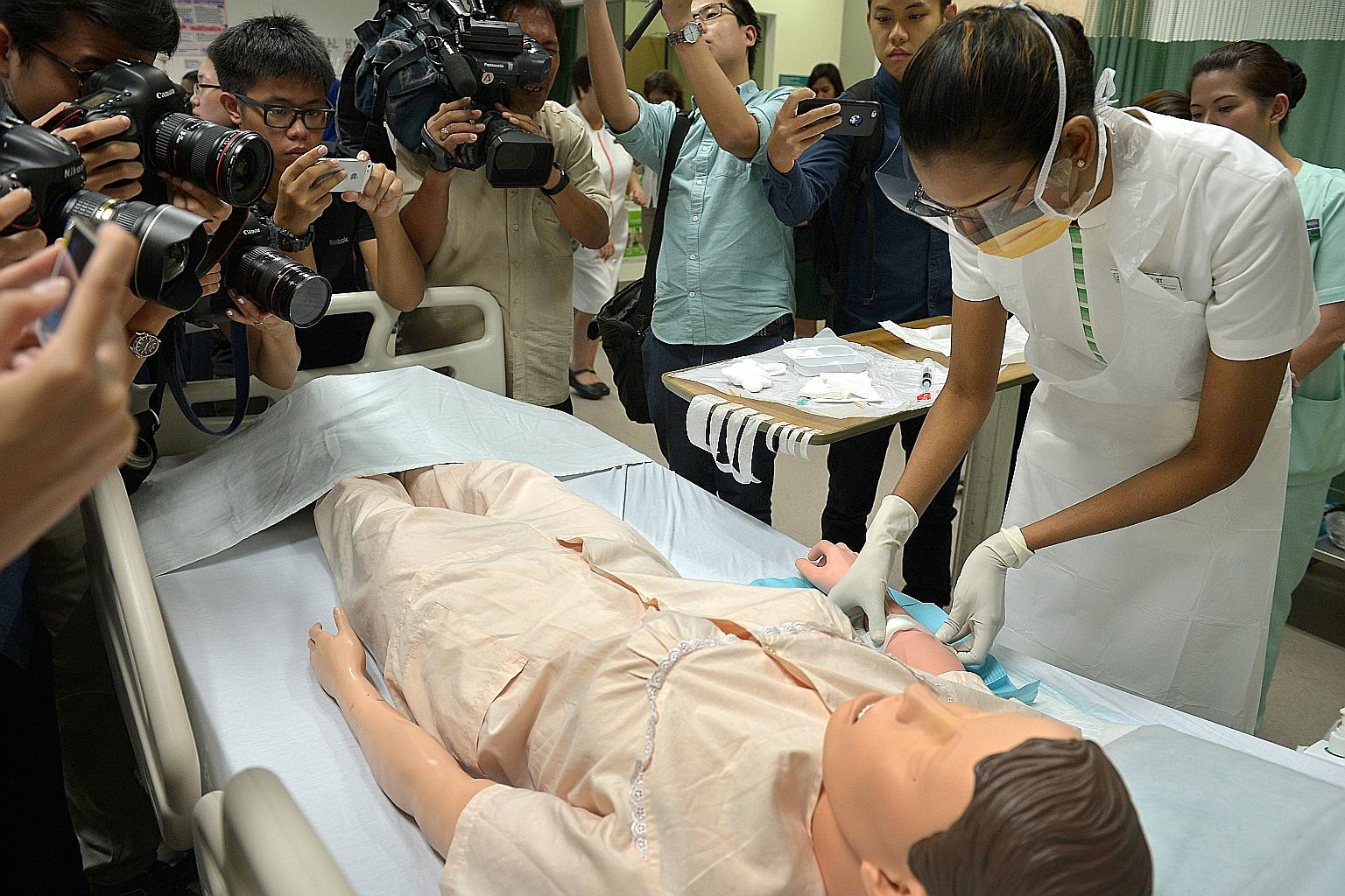 A nurse giving a demonstration on patient safety and infection control measures at SGH in October during a media tour. An independent committee found that poor infection control caused the hepatitis C outbreak there earlier this year. Some 25 kidney 