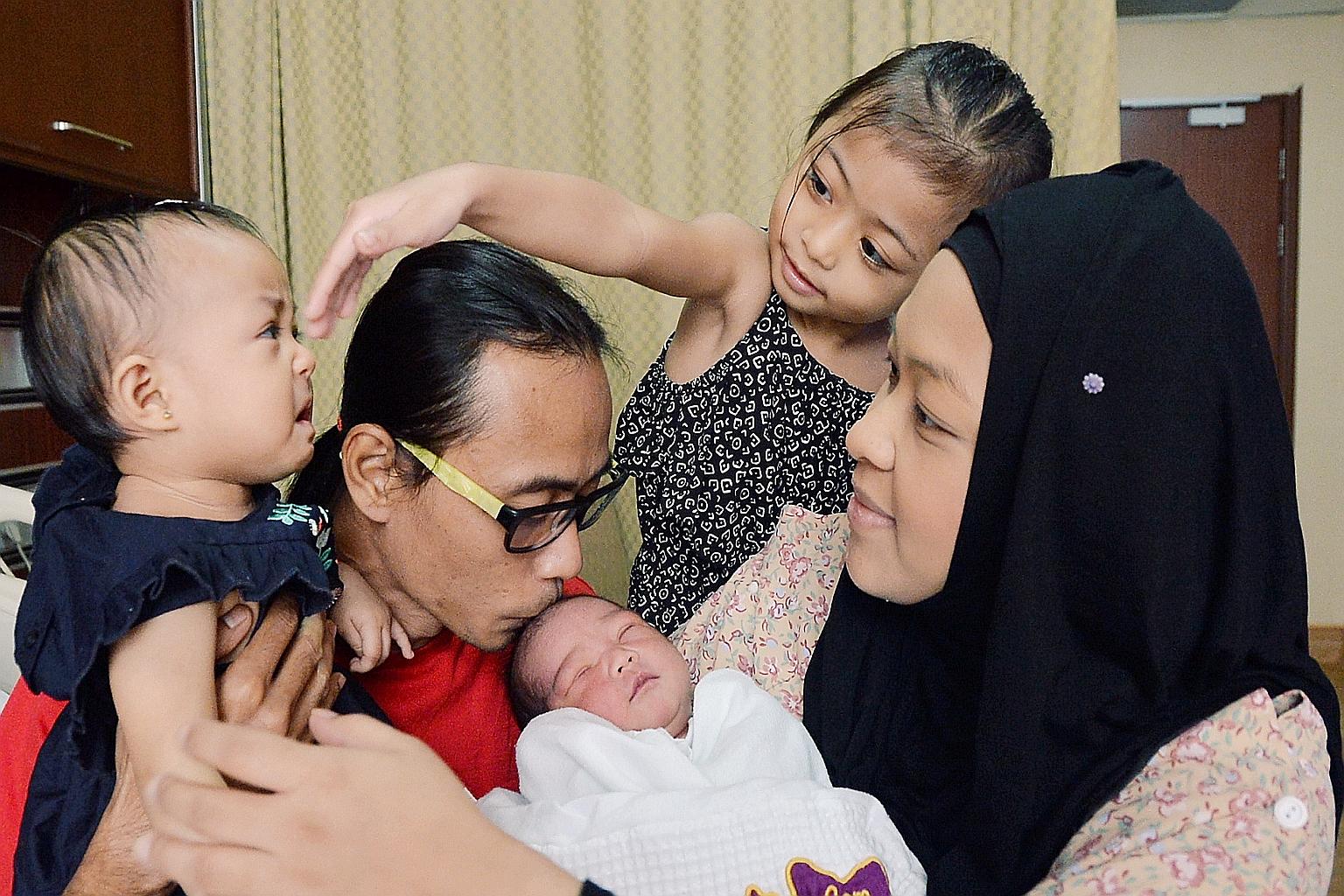 Madam Lydiawati gave birth to Mohammad Rifly Asyraaf on Monday, 10 months after younger daughter A'lya Aamily Delisha was born. With them are Mr Mohamad Ali and older daughter A'lya Mayli Shazya.