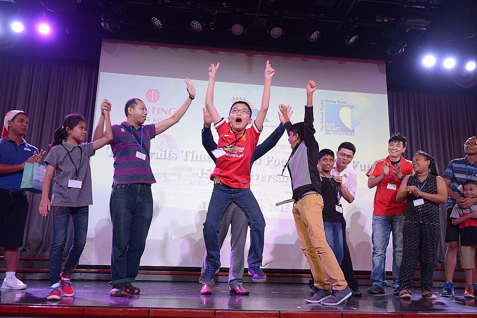 The Straits Times School Pocket Money Fund beneficiaries, their family members, cruise ship crew and Singapore Press Holdings staff having fun playing games at the SuperStar Gemini's show lounge yesterday. The underprivileged kids and their family me