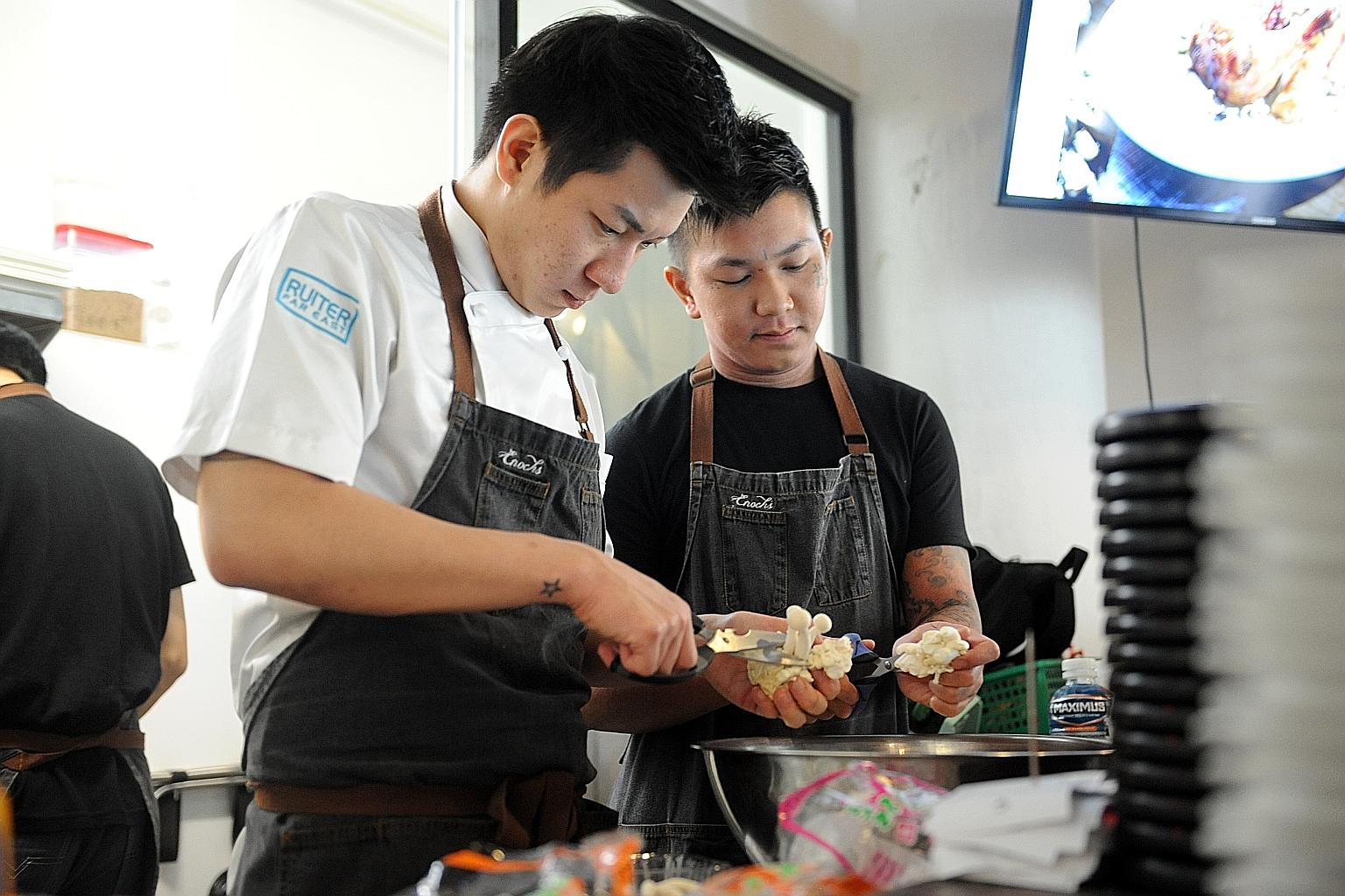Mr Enoch Teo (left), one of the two founders of E&I Food Concepts, is a former at-risk youth. E&I runs three food outlets.