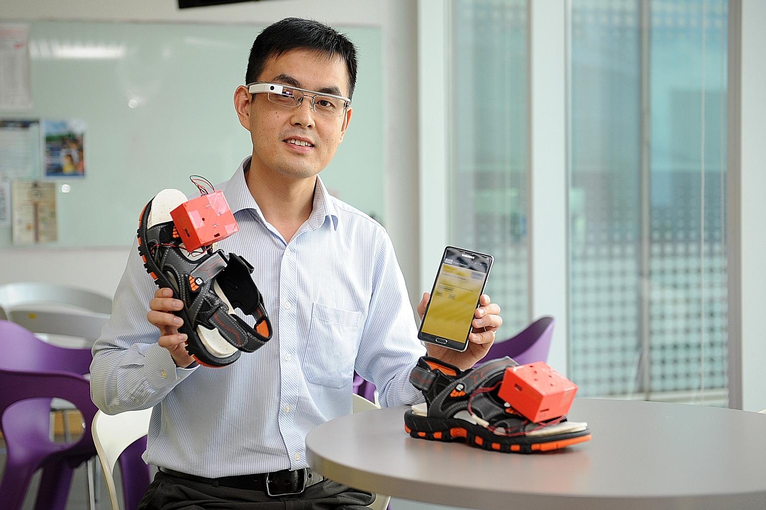 Dr Xu Qianli with the prototype of his wearable navigation assistance for the visually disabled. It comprises a Google Glass device, a mobile phone app and vibrating motors that can be embedded in a user's shoes.