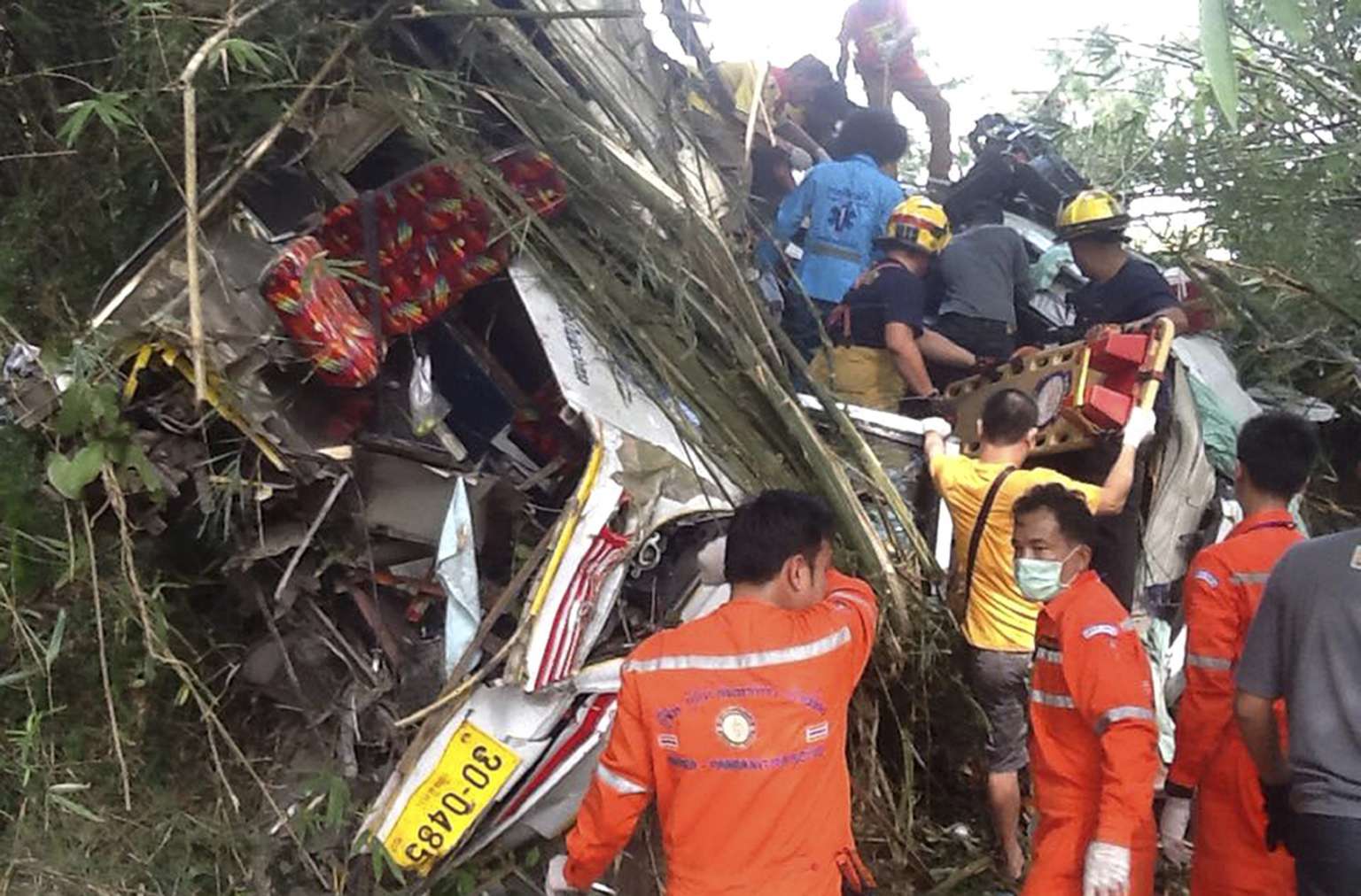 Tour bus plunges into ravine as driver flees crash with truck; 13 ...