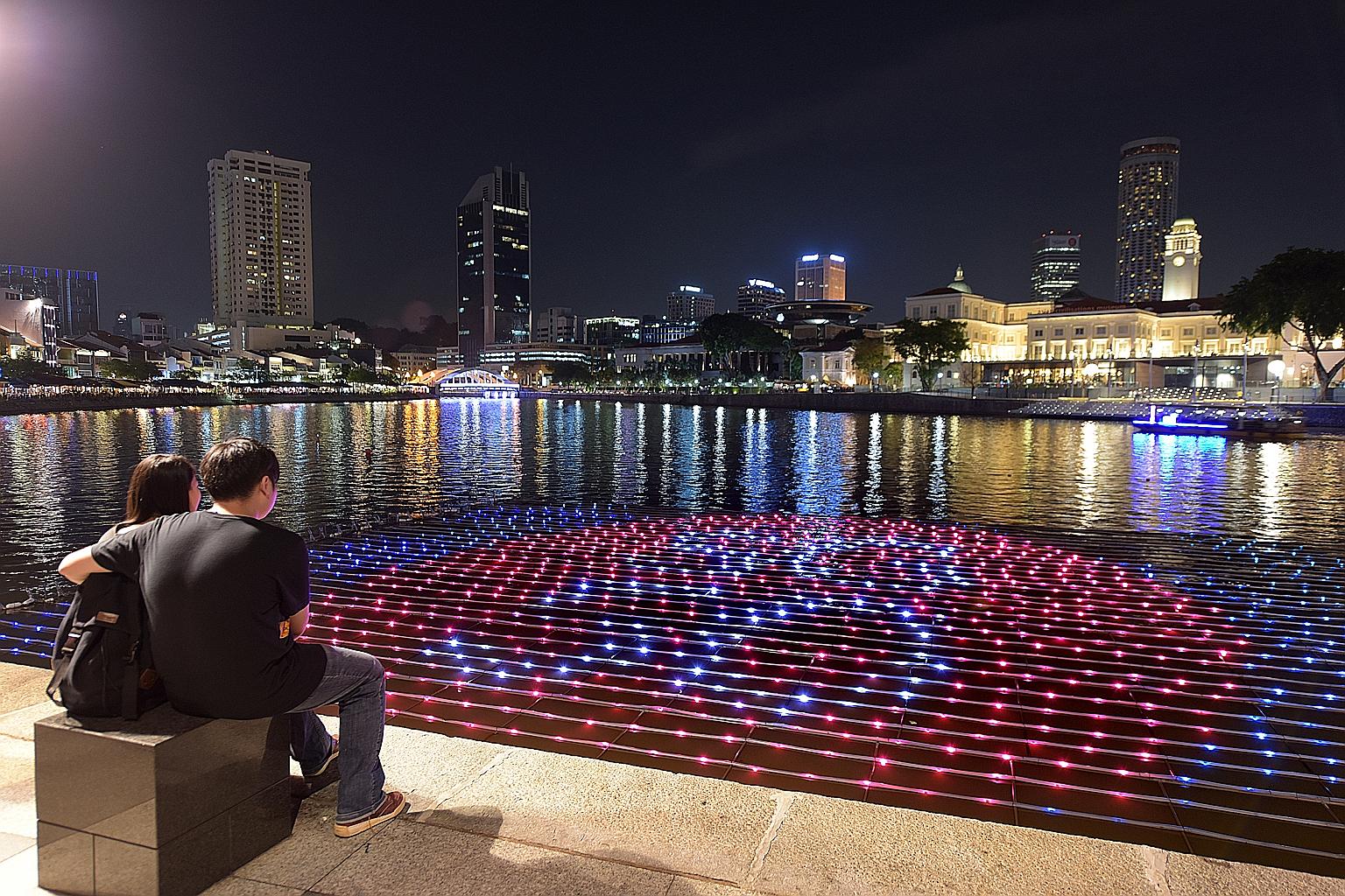 The Singapore River is lit up by a new floating art installation, which visitors can interact with using their mobile devices. The display - shaped like a map of Singapore - makes use of more than 2,000 LED lights. Visitors can send New Year wishes v