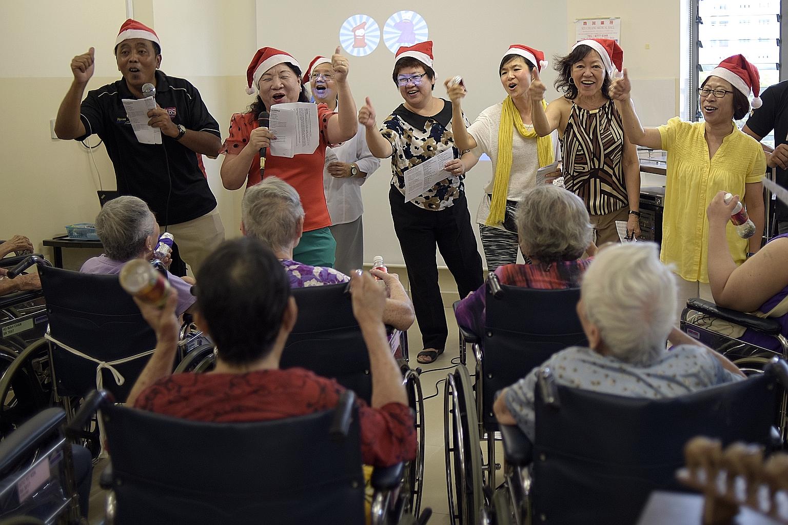 Ms Lee Guek Meng spending time with Mr Brian Goh at the Villa Francis Home for the Aged in Yishun. Mr Goh, 77, has been living in Villa Francis for the past 12 years. Ms Lee is one of 11 people who have just finished the Certificate in Spiritual Care