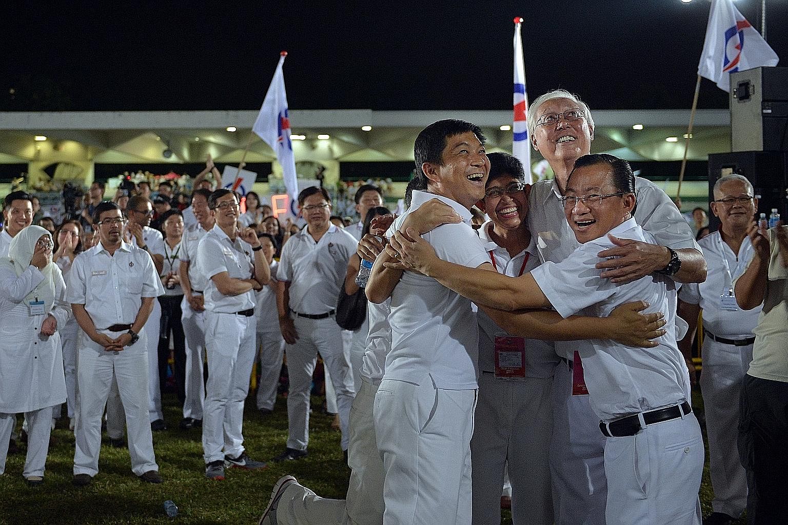 6 VICTORY HUG (far left) The People's Action Party's Marine Parade GRC team - (from left) Mr Tan Chuan-Jin, Mr Edwin Tong (hidden), Dr Fatimah Lateef, Mr Goh Chok Tong and Mr Seah Kian Peng - celebrating their win in the Sept 11 General Election afte