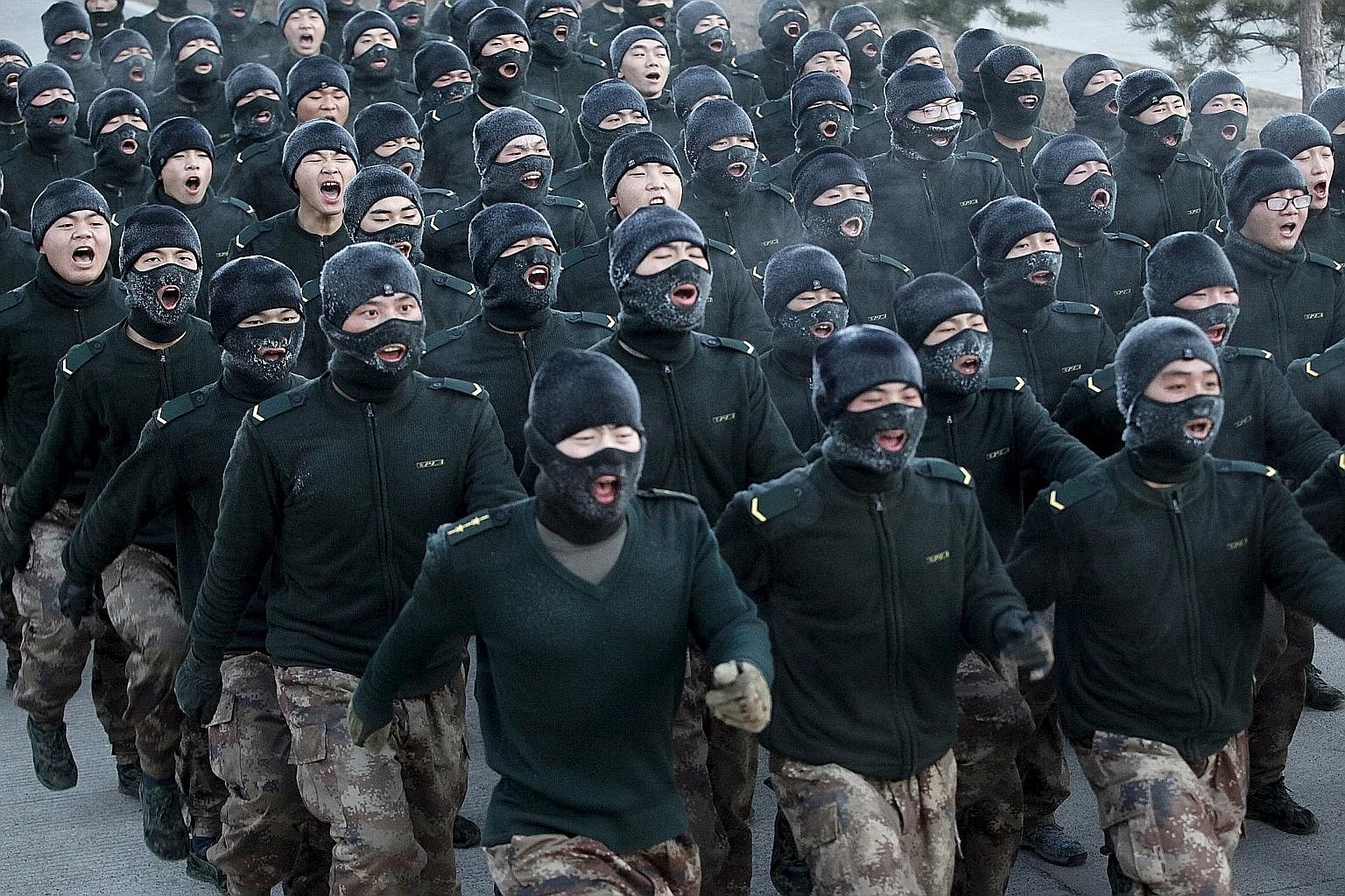 People's Liberation Army recruits shout slogans as they march during a training session in cold winter temperatures at a military base in China's Heilongjiang province. President Xi is pushing on with tough military reforms and an anti-corruption dri
