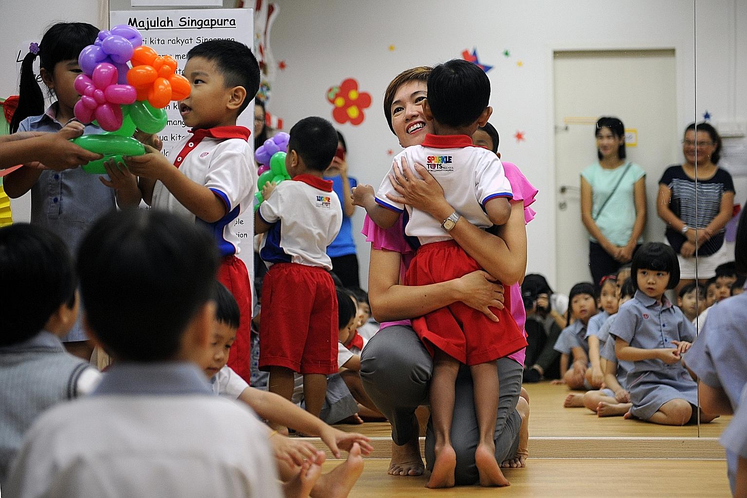 Mrs Teo welcoming children back to school at the PAP Community Foundation Sparkletots Childcare in Bishan yesterday. The Senior Minister of State said she will focus on ensuring a conducive environment for couples to start a family, among other prior