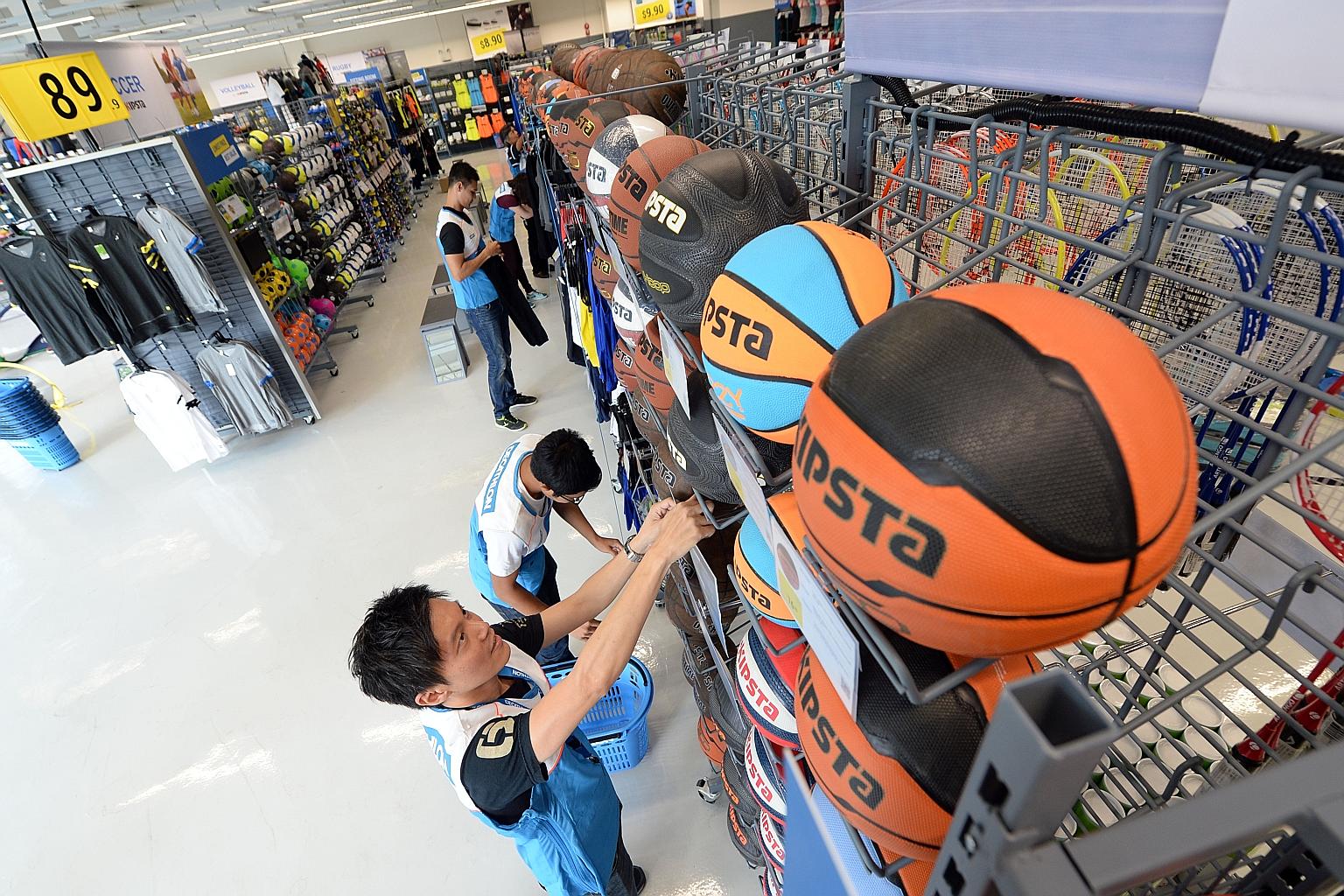 Decathlon staff preparing for the store's opening on Saturday in Viva Business Park in Chai Chee. The French sporting goods retailer signed a lease for more than 15 years for the 35,000 sq ft outlet.