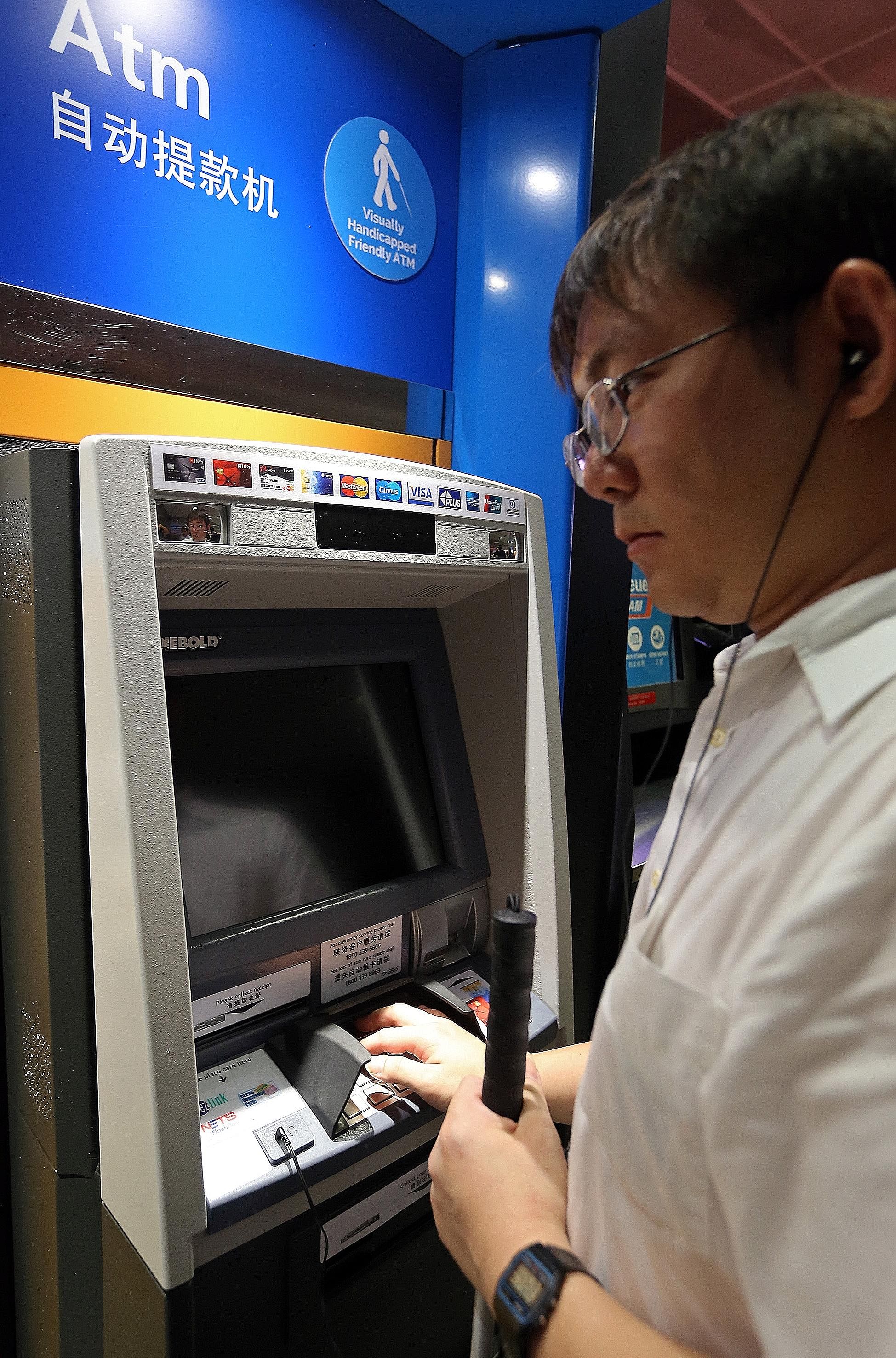 The ATMs are enhanced with user-friendly functions for those who have visual disabilities, such as Braille instructions (left, top) and audio guidance. The user simply has to plug his or her earphones into the ATM's audiojack (left, bottom) to activa