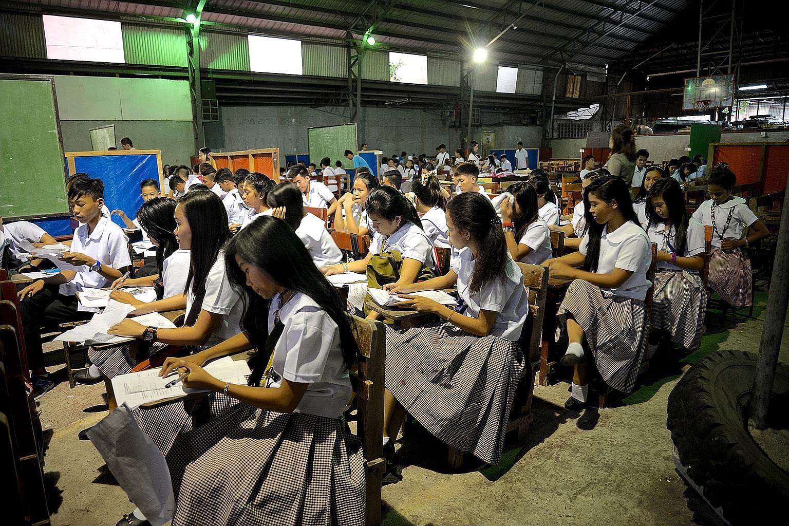 Students at the San Rafael Technological School in Navotas city, just an hour north of Manila, having classes inside a gymnasium. A new school building is being constructed that will give the 1,008 students 16 classrooms, double what they had before.