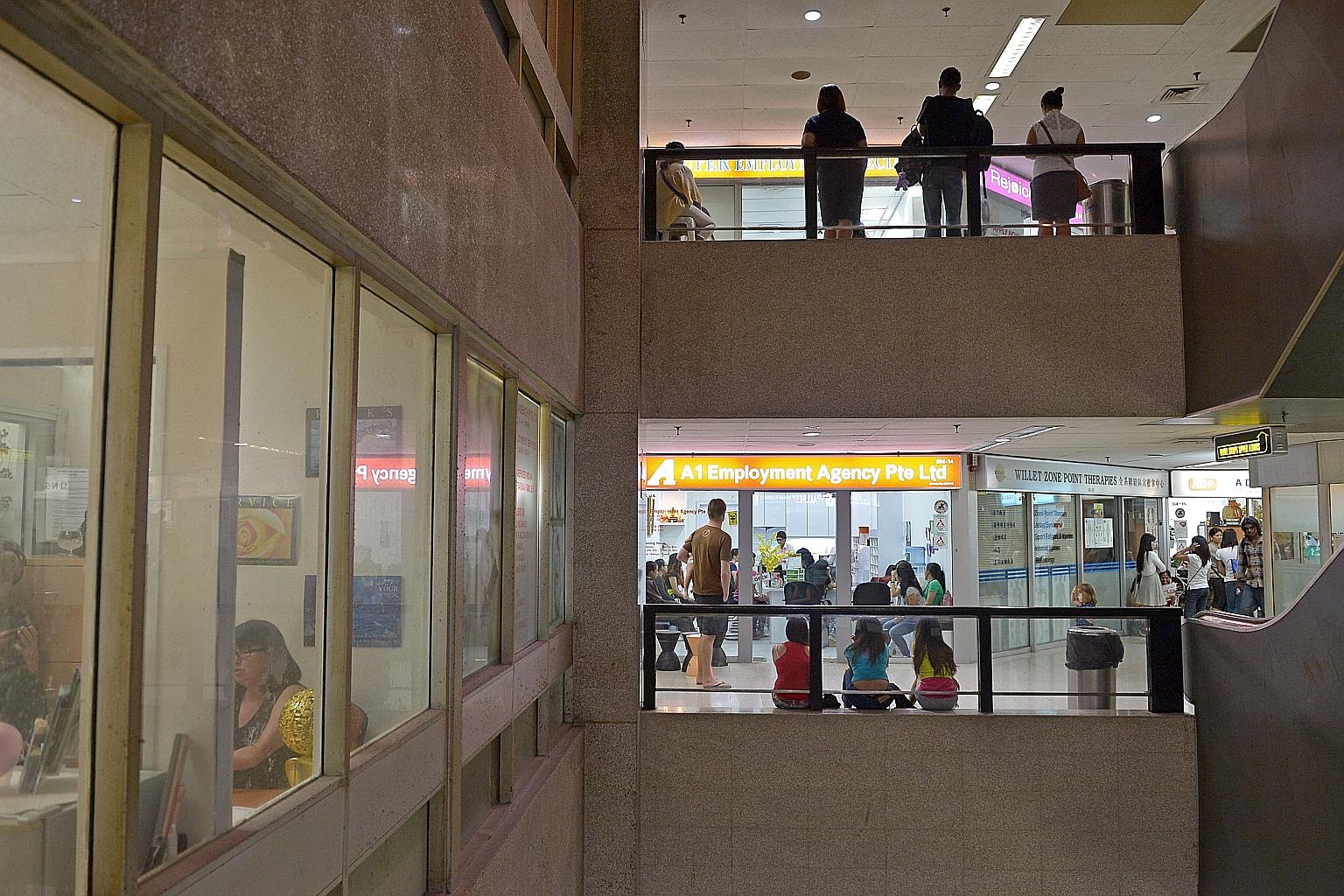 Domestic workers waiting outside employment agencies at Far East Shopping Centre to speak to potential employers. The apparent pay hike for Filipino maids comes three months after a similar move by the Indonesian Embassy here for domestic workers fro